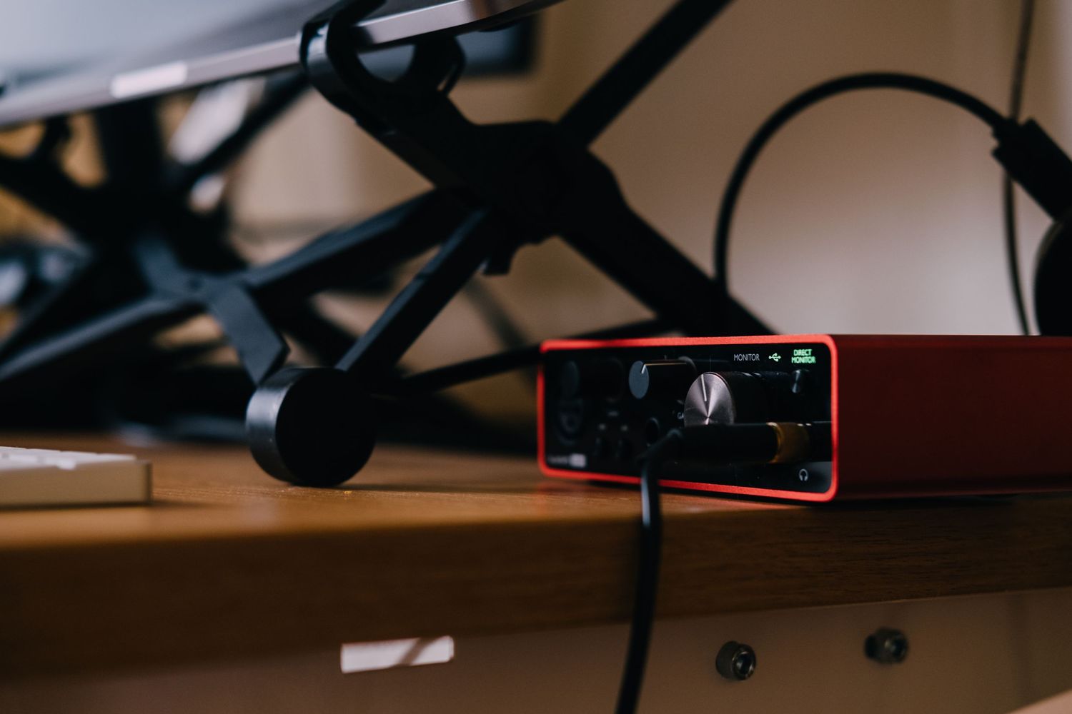 Close-up of recording equipment with red smartphone mounted on desk.