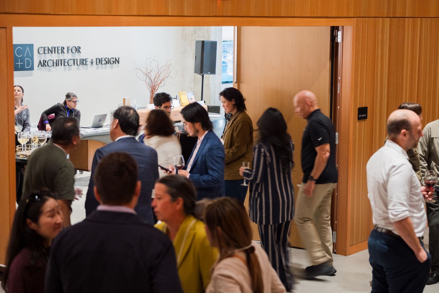 Professionals networking at the Center for Architecture and Design event in a modern venue.