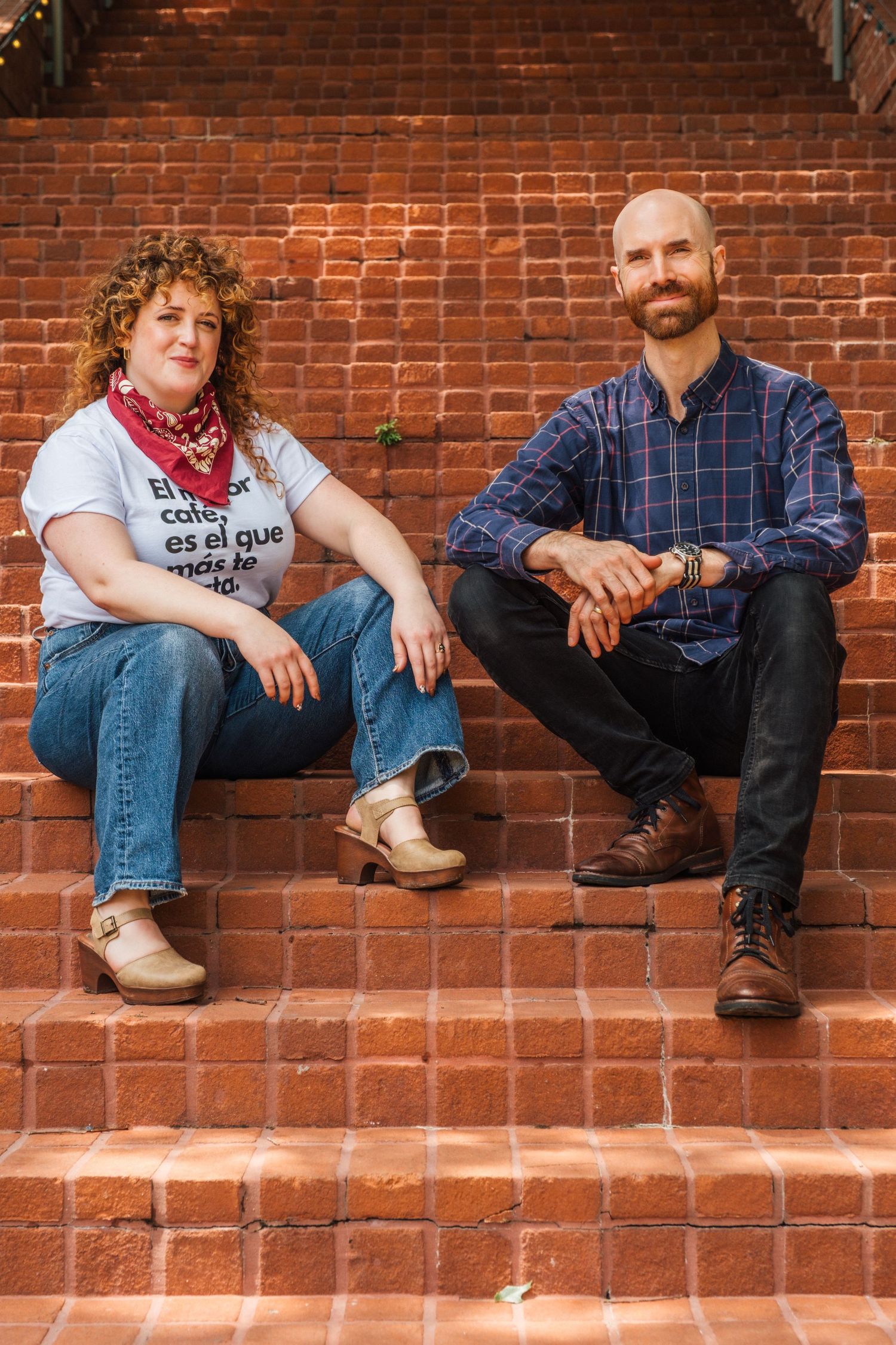 Four casual photos of people sitting on brick steps in denim jeans and casual wear against a rustic brick wall.