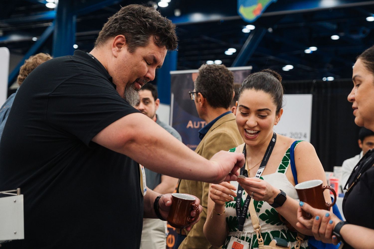 Group of people interacting at a conference or trade show.