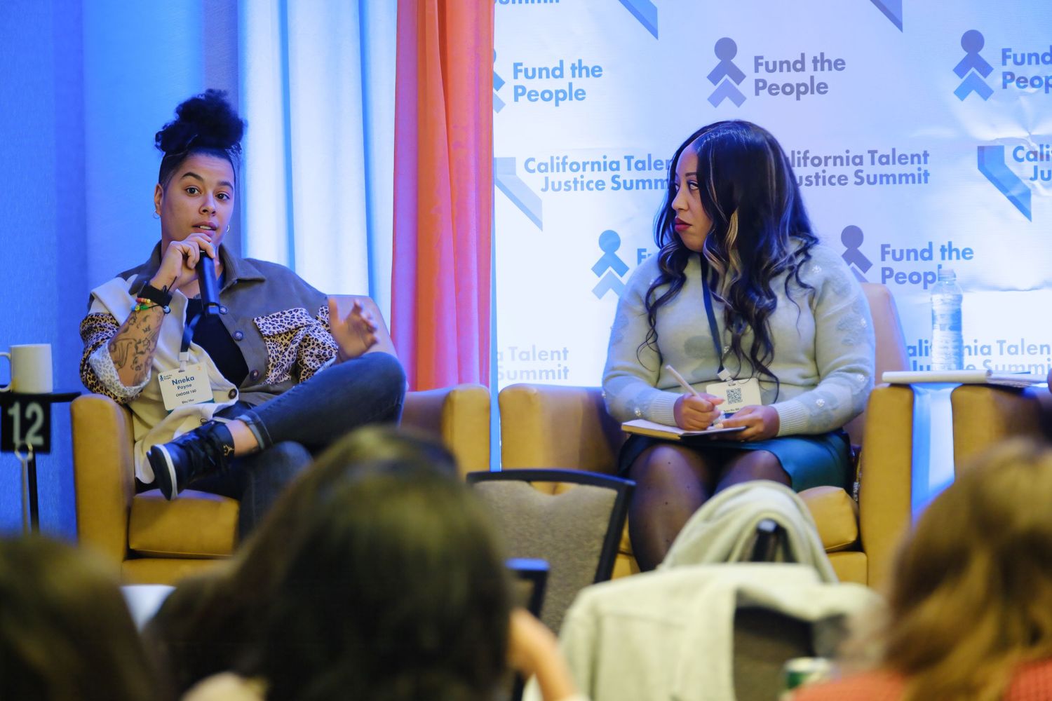 Speakers participating in a panel discussion at a professional conference.