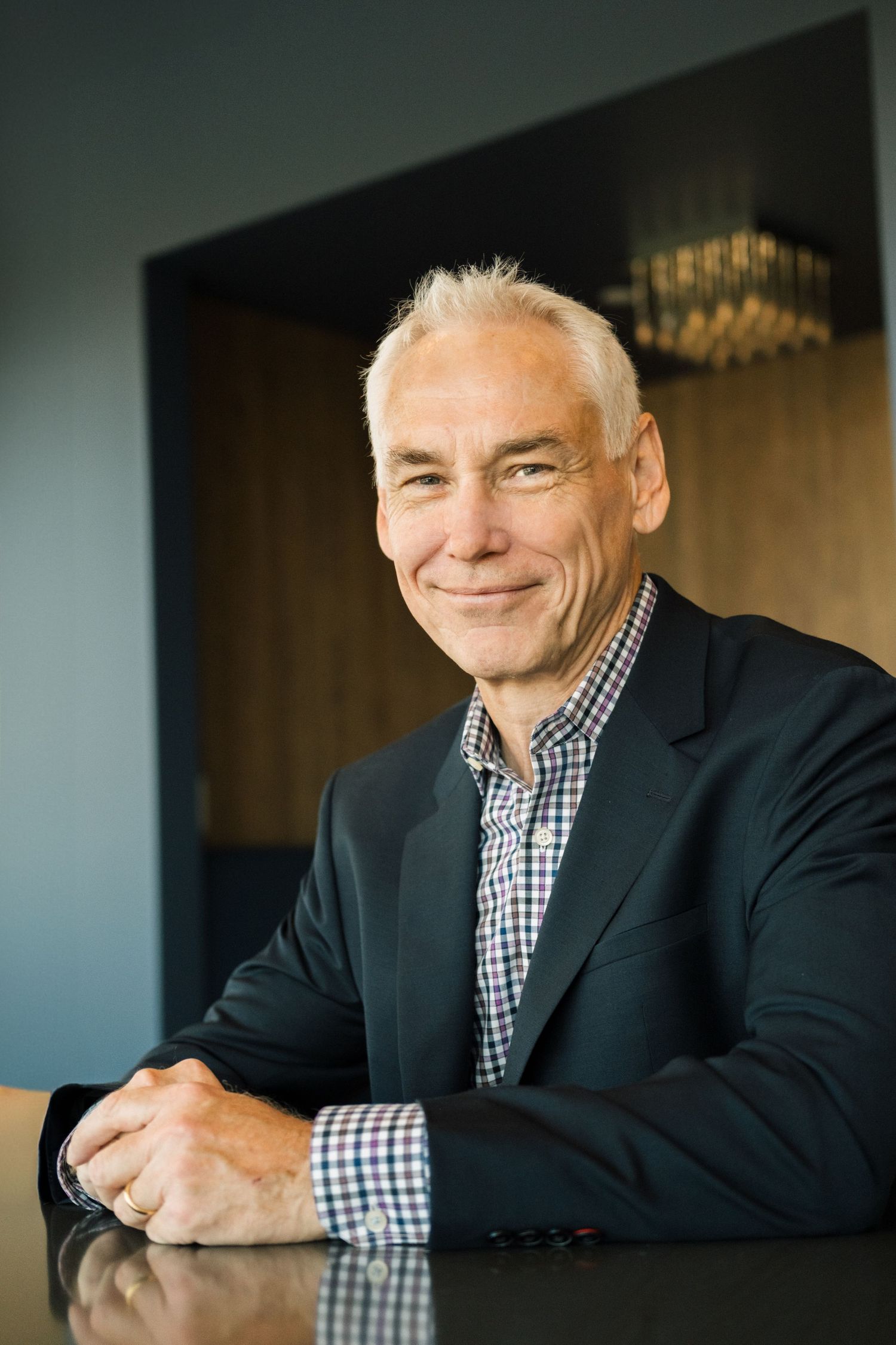 Professional business portrait series showing expressions of warmth and confidence against dark background.