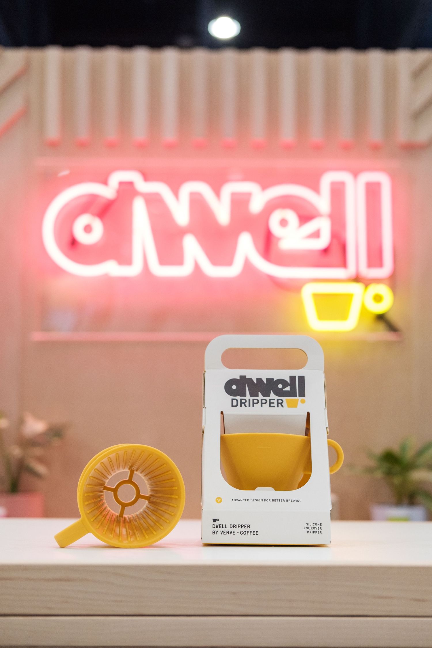 Yellow smiley face neon light sign glowing against a dark background.
