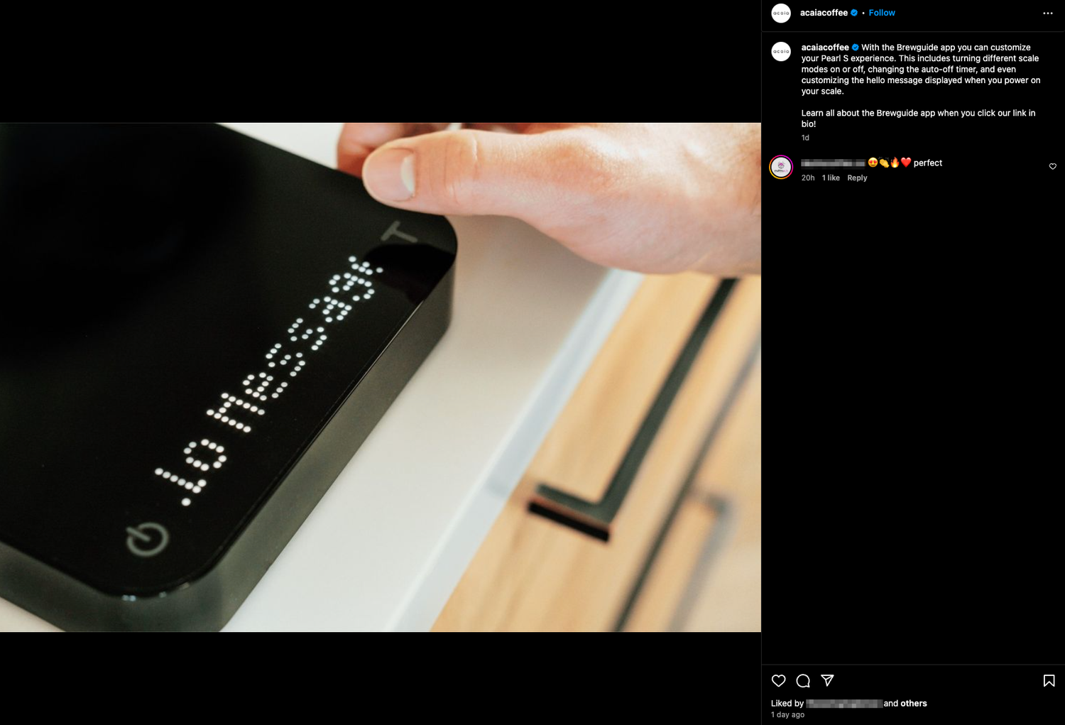 Close-up shot of a black coffee brewing device with white text display.