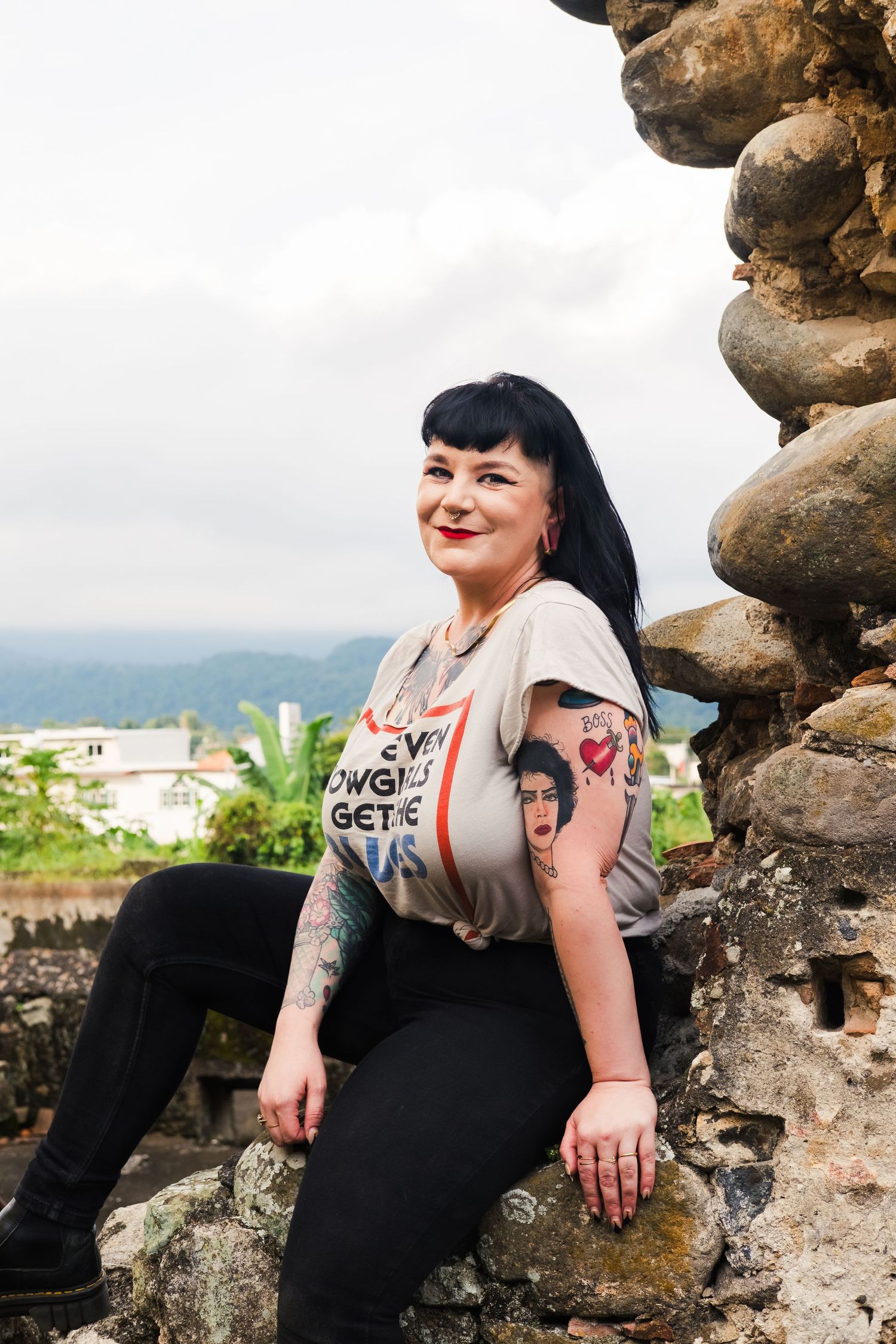 Creative, lifestyle, outdoor portrait of tattooed queer woman. A fun full-body headshot during a personal branding photoshoot.