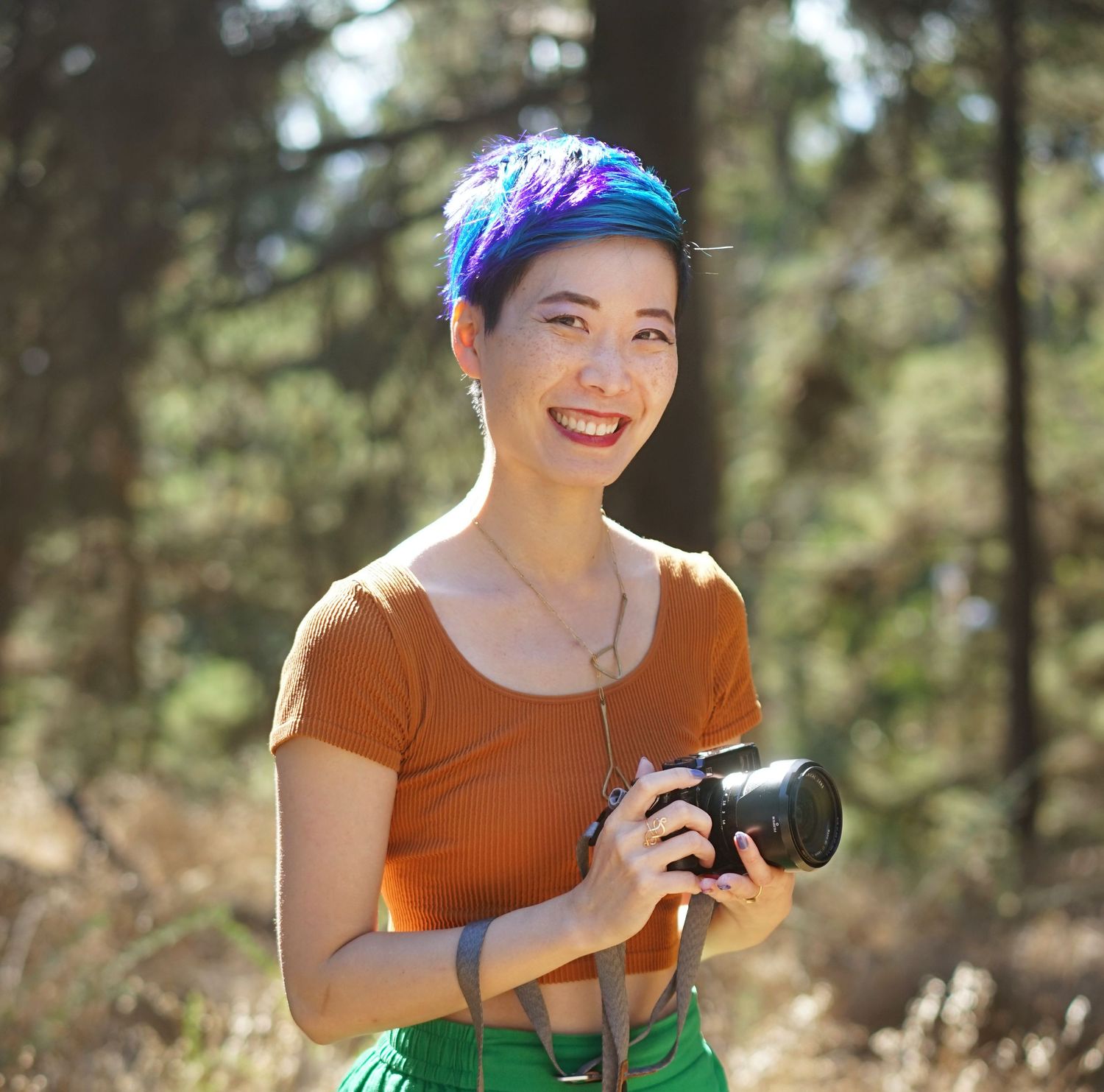 Someone enjoying outdoor photography in a forest setting.