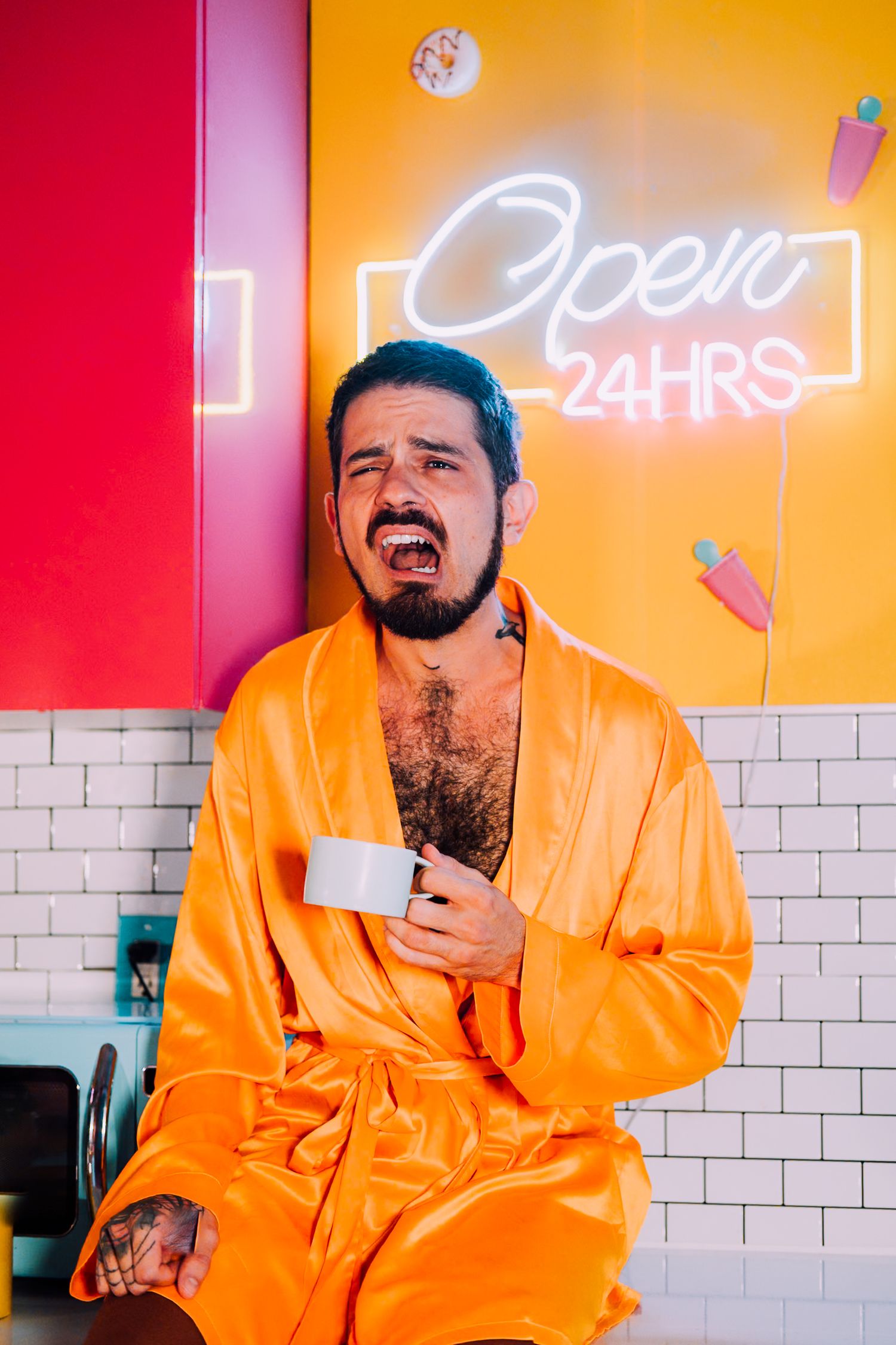 Person in bright orange jacket poses against colorful wall with neon signs in a series of expressive shots.