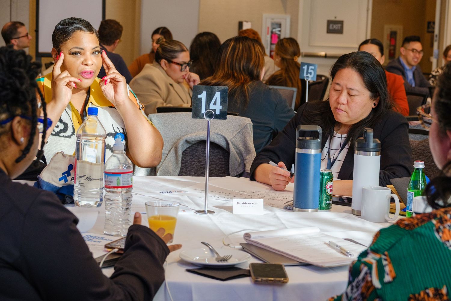 Conference attendees sitting at round tables during professional development session.
