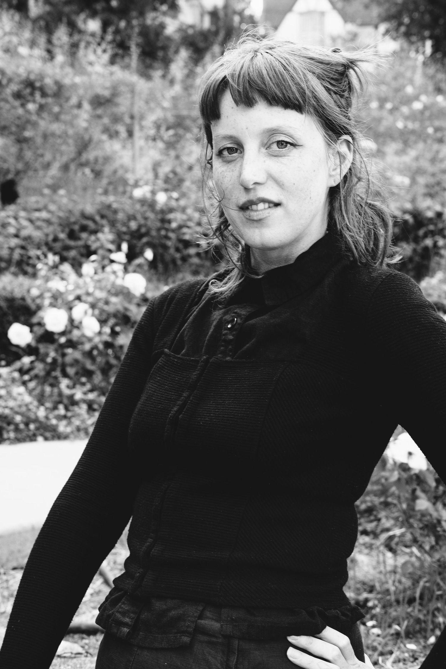 Classic black and white portrait in a garden setting.