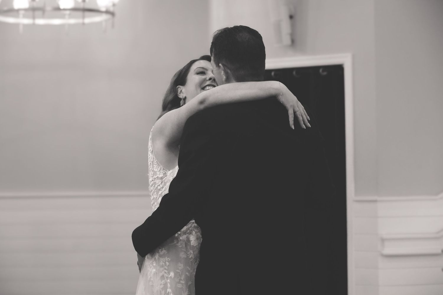 Black and white photo series showing a couple embracing and dancing together in an intimate moment.