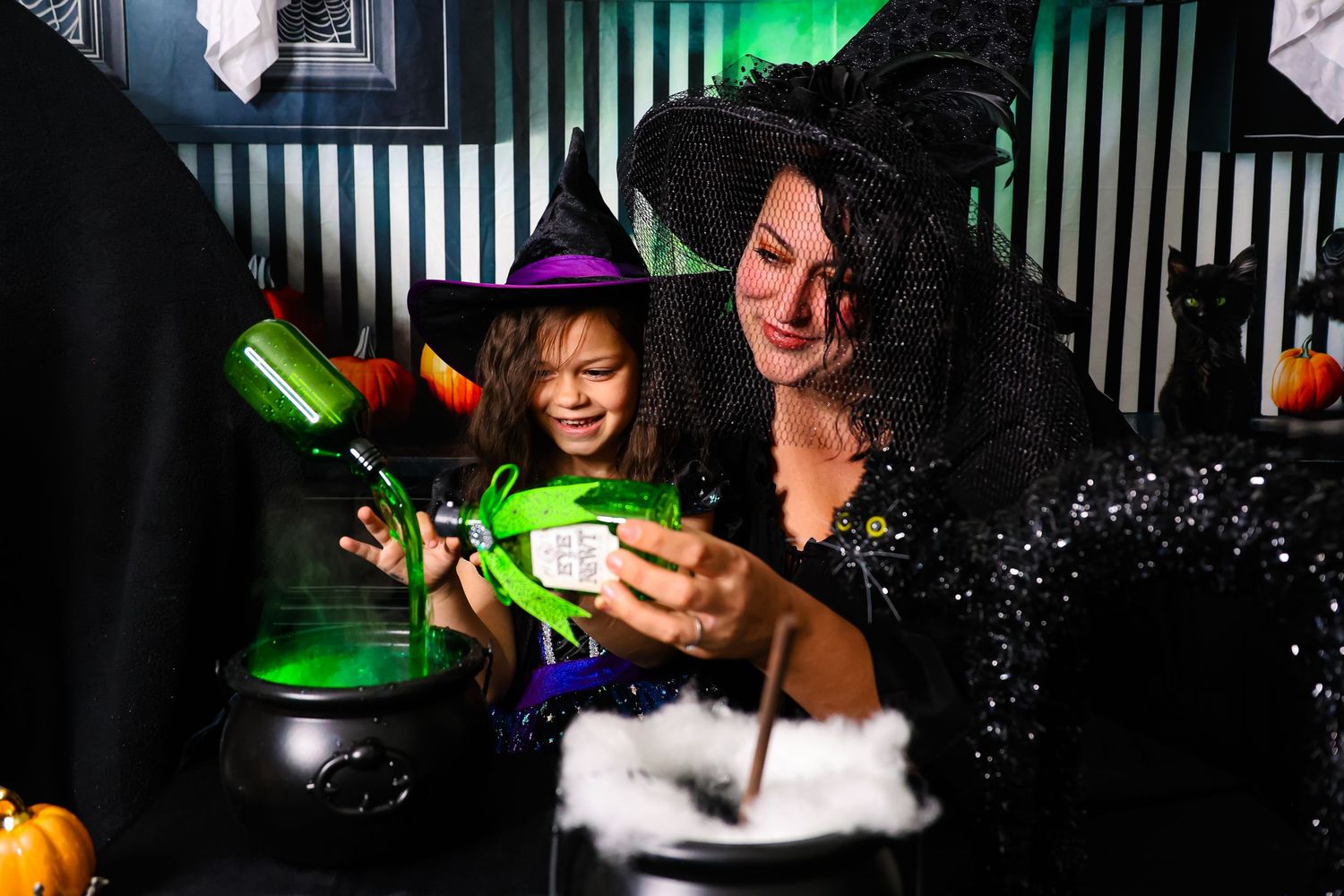 People enjoying a nightclub atmosphere with green lighting and drinks at a crowded bar.