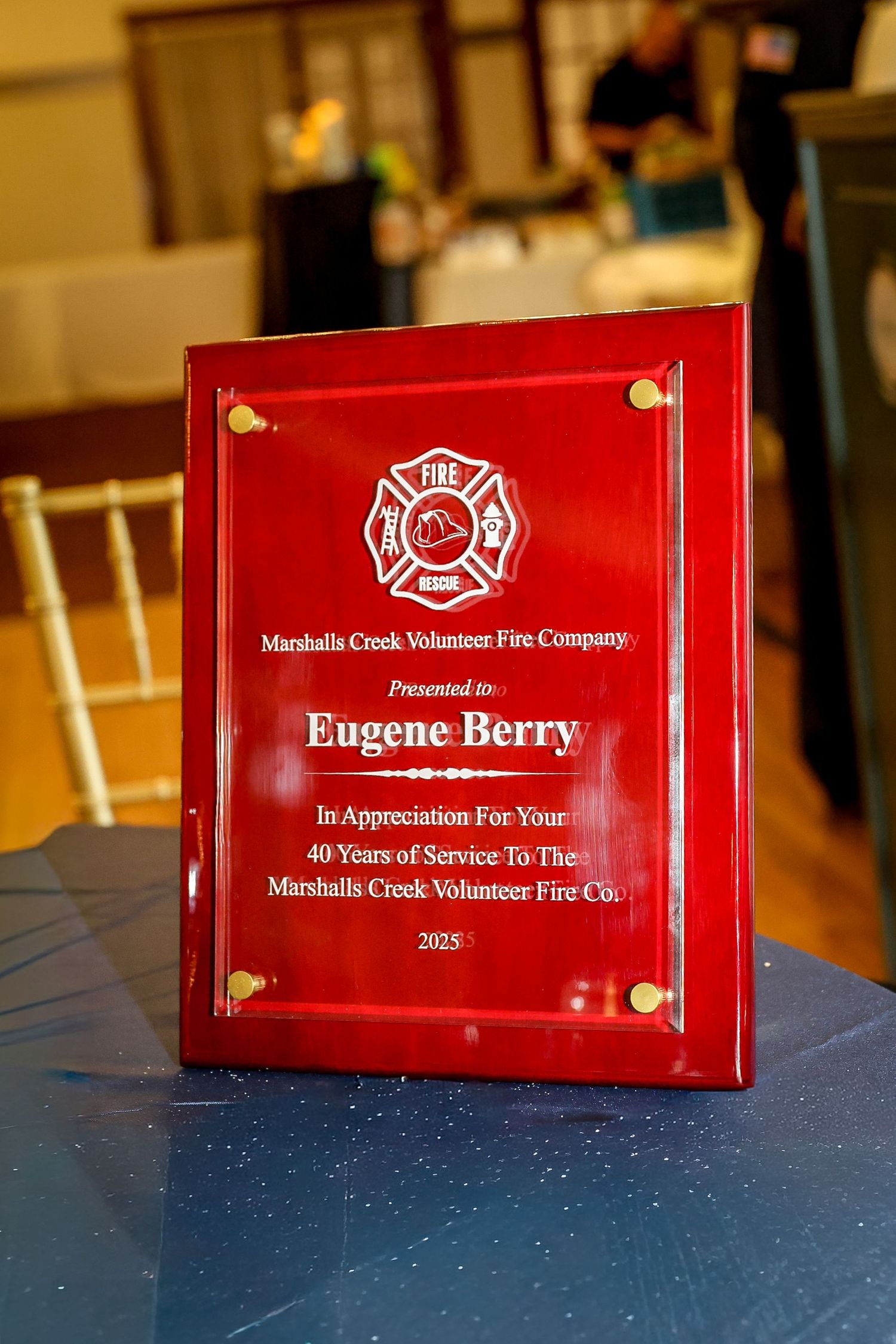 Red plaque honoring Eugene Berry for 40 years of service to Marshalls Creek Volunteer Fire Company, 2025.