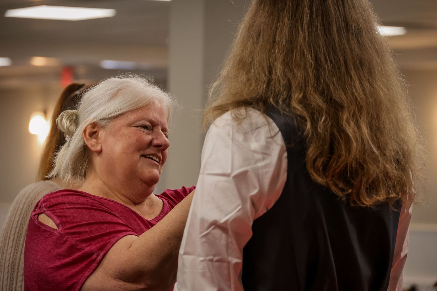 A collage of intimate moments shows people embracing and comforting each other in what appears to be a healthcare setting.