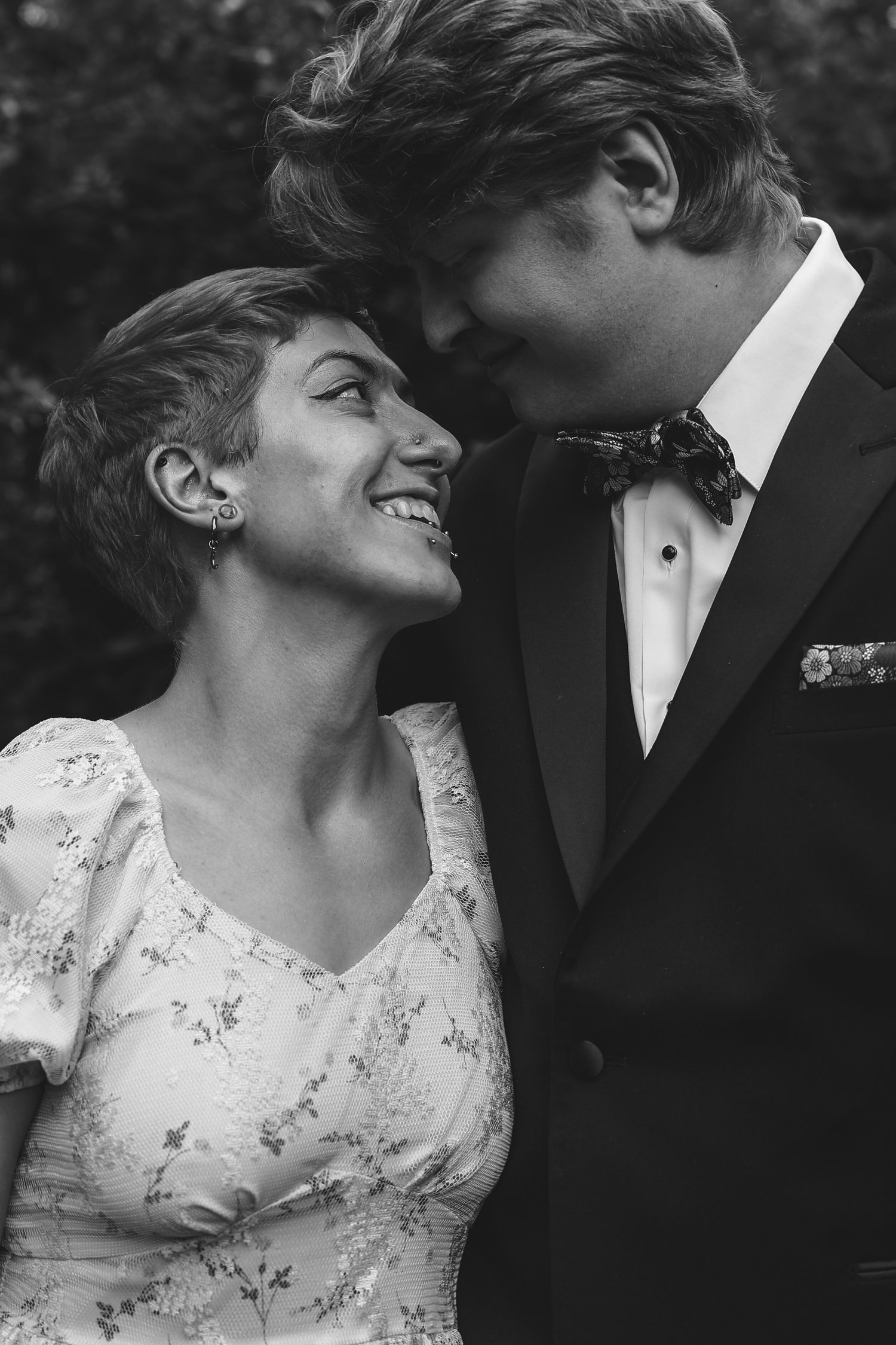 A romantic black and white photo sequence showing a couple in wedding attire sharing an intimate moment together.