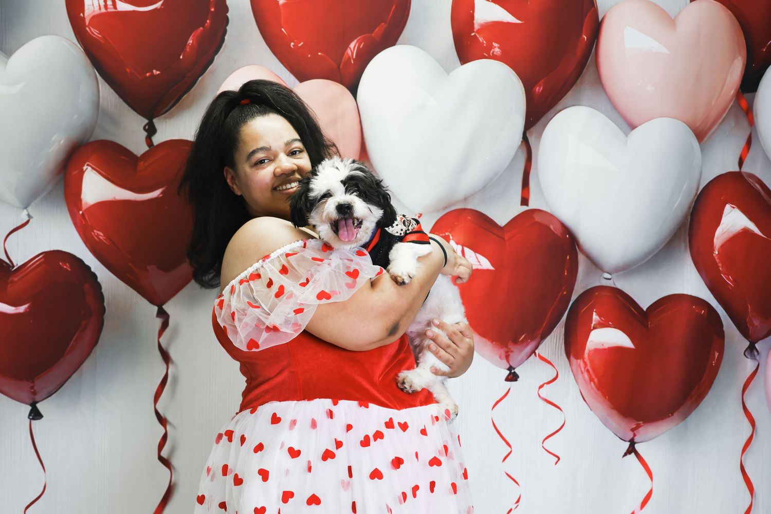 A festive party scene with red and white balloons creating a romantic Valentine's Day backdrop.