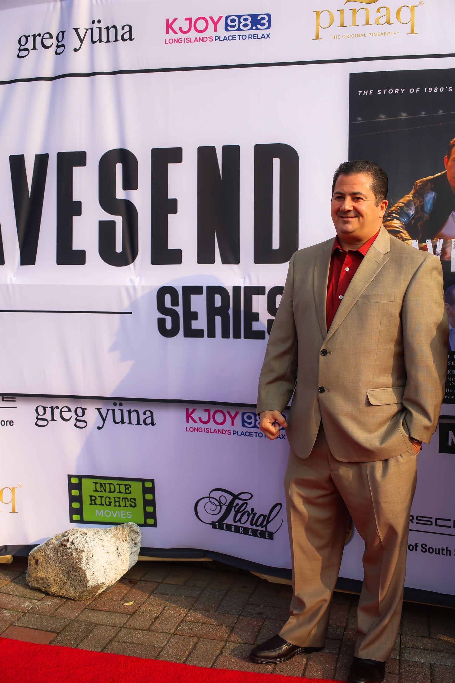 A series of promotional photos showing someone in a tan suit standing against a branded backdrop with radio station logos.