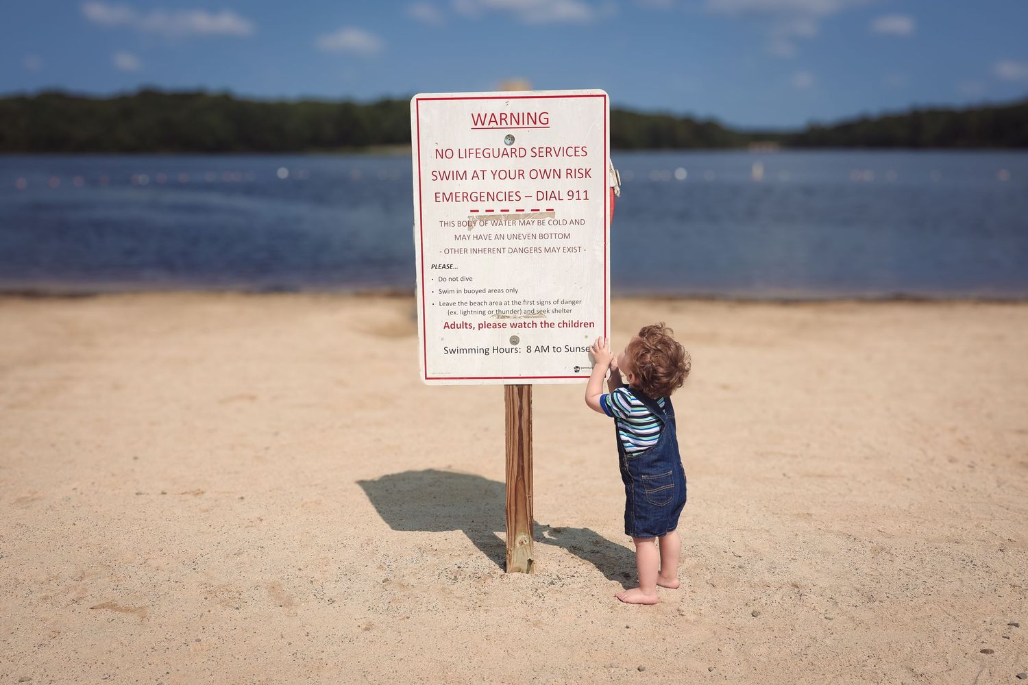 A sequence of photos showing a small child reading warning signs on a sandy beach near the water.