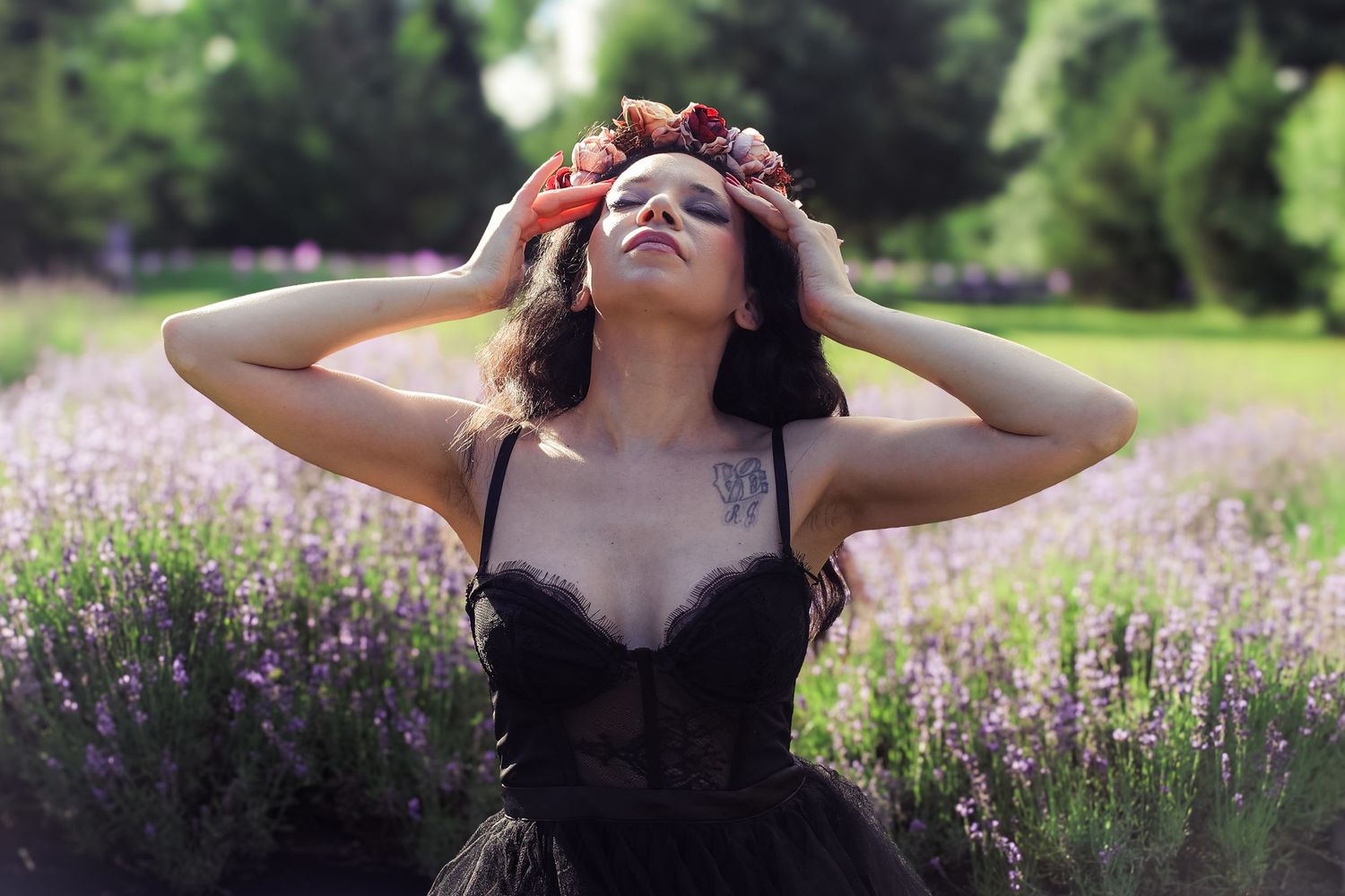 A figure poses gracefully in a blooming lavender field during sunset, creating a dreamy summer scene.