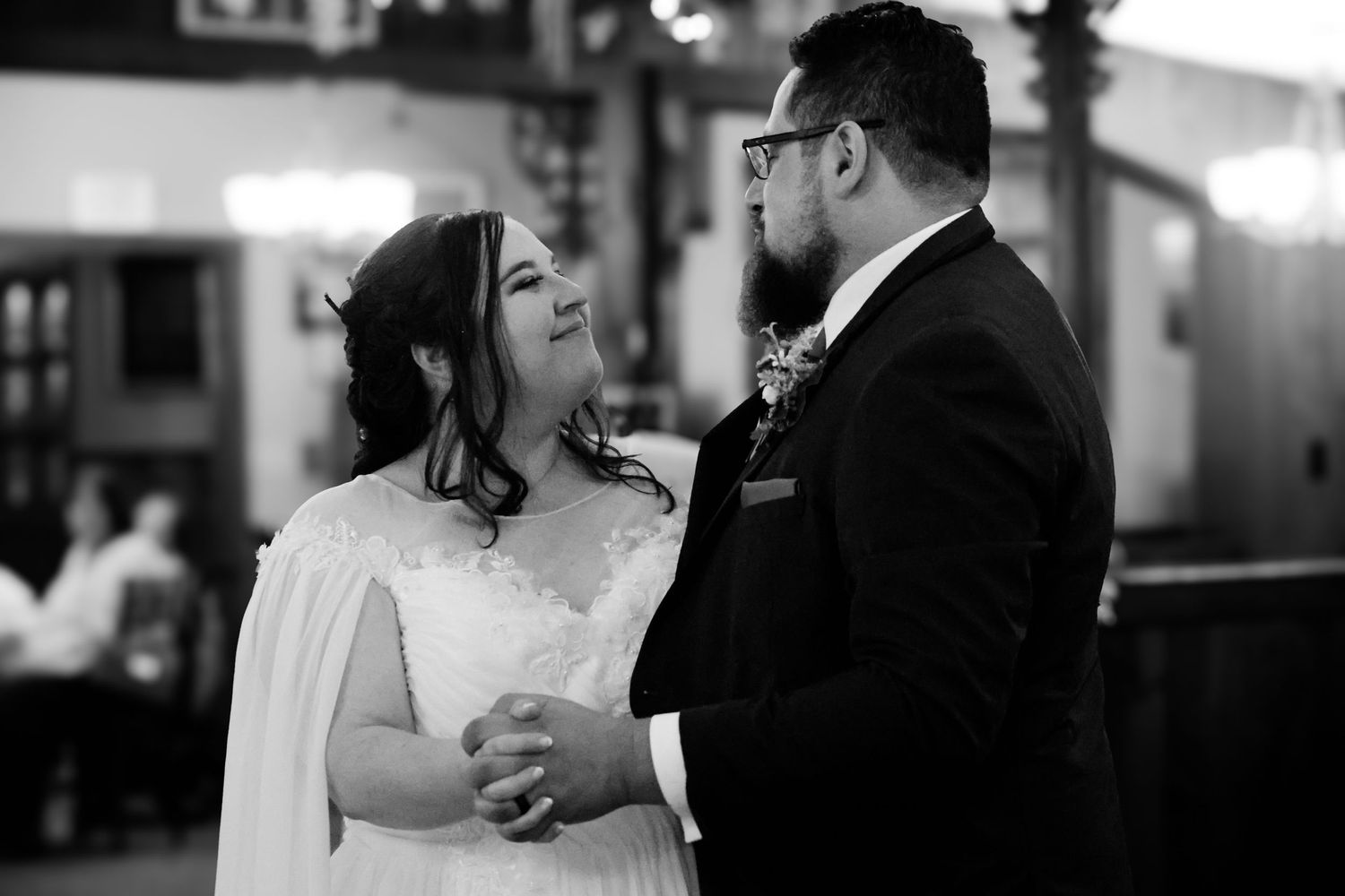 Black and white wedding photos showing intimate dance moments between couples at their reception celebration.