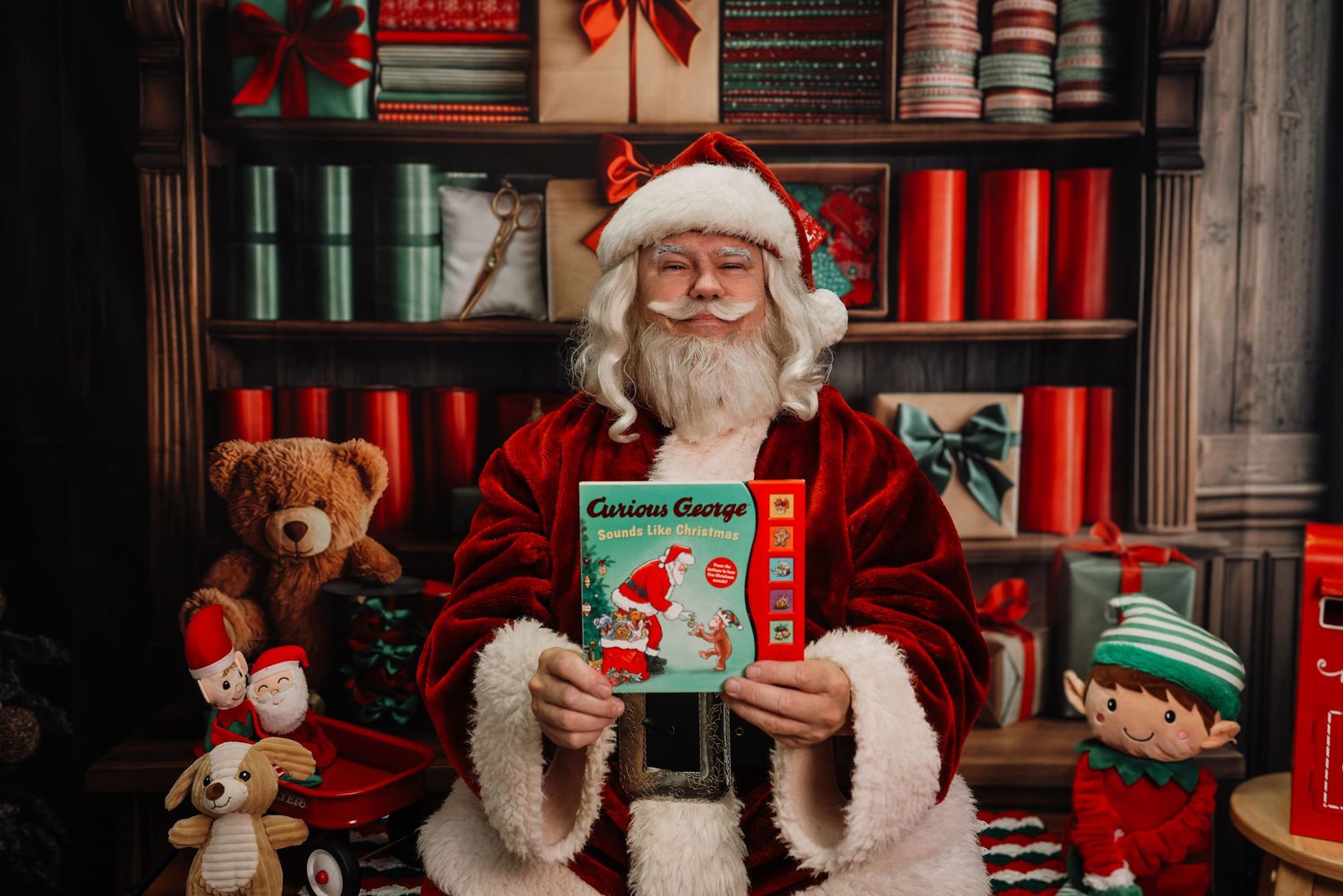 A festive holiday display features Santa Claus figures, red ribbons, and Christmas decorations in a storefront window.