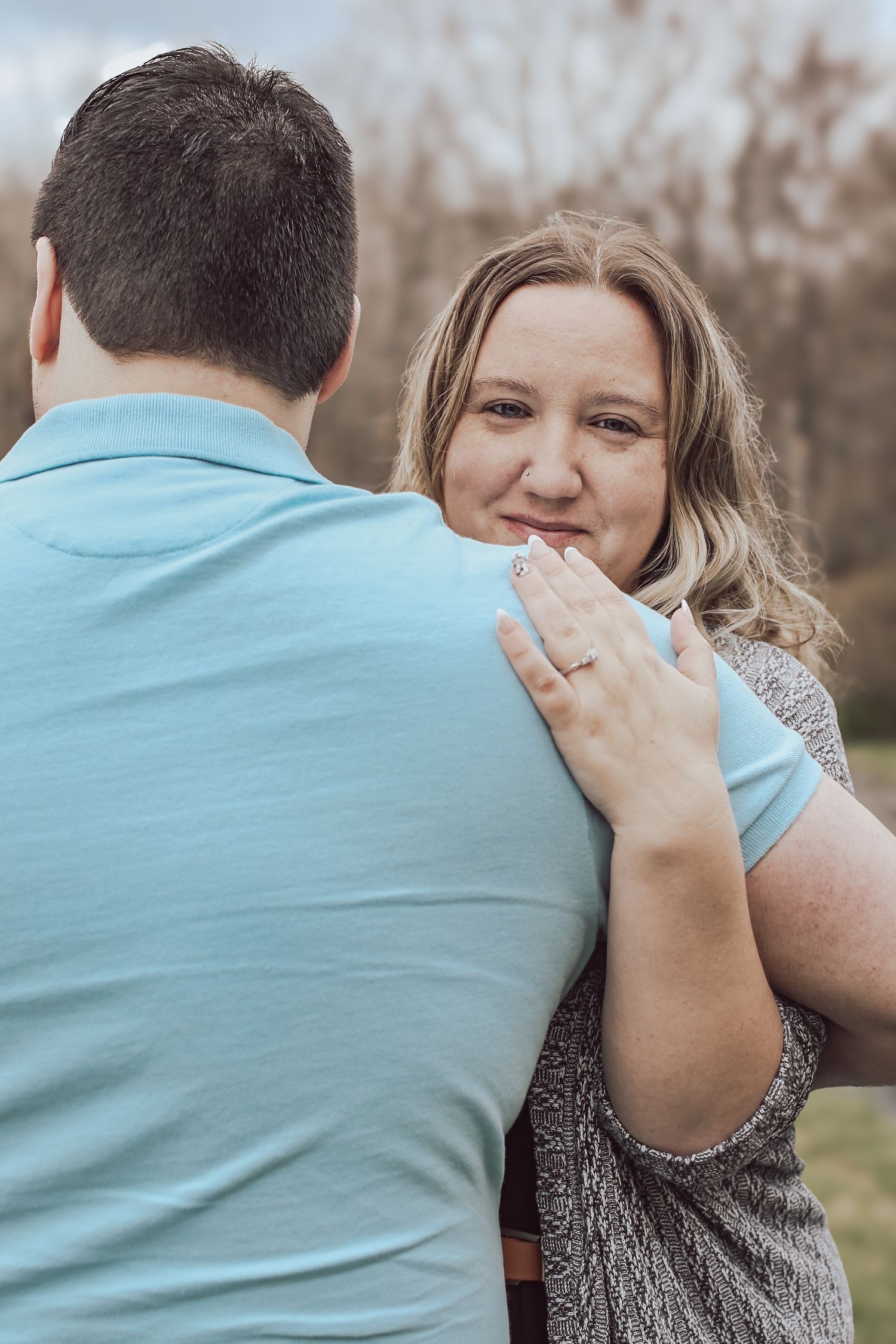 A series of photos showing a couple in a romantic outdoor proposal sequence with one wearing a blue shirt.