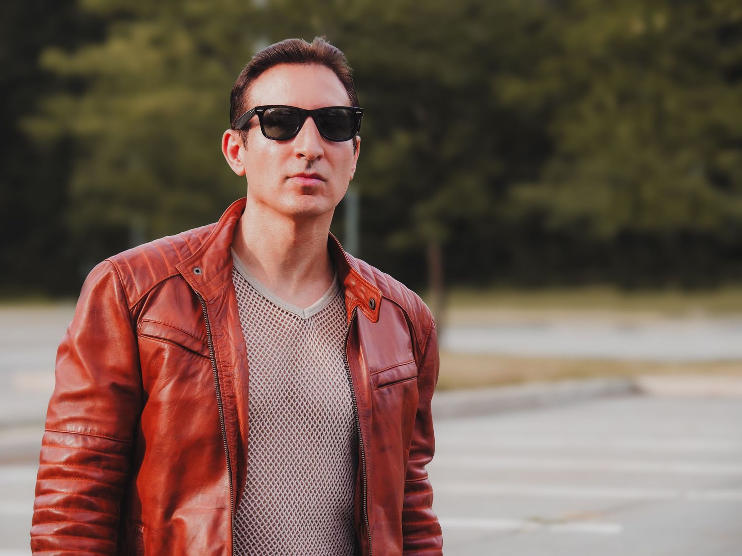 A person wearing a red leather jacket and sunglasses poses outdoors in a collage of similar photos.