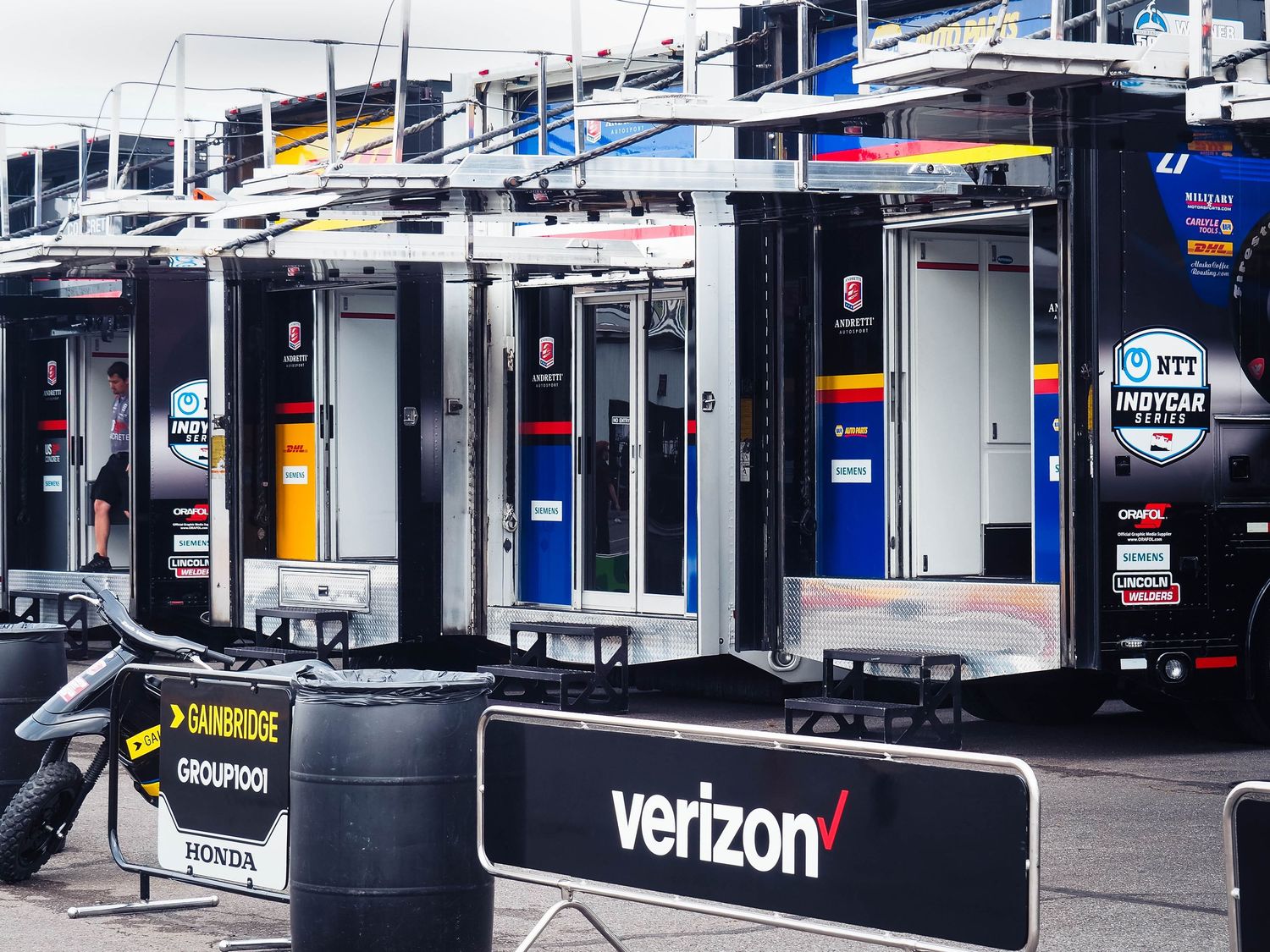 Verizon retail store exterior with multiple storefronts and signage visible in a shopping center.