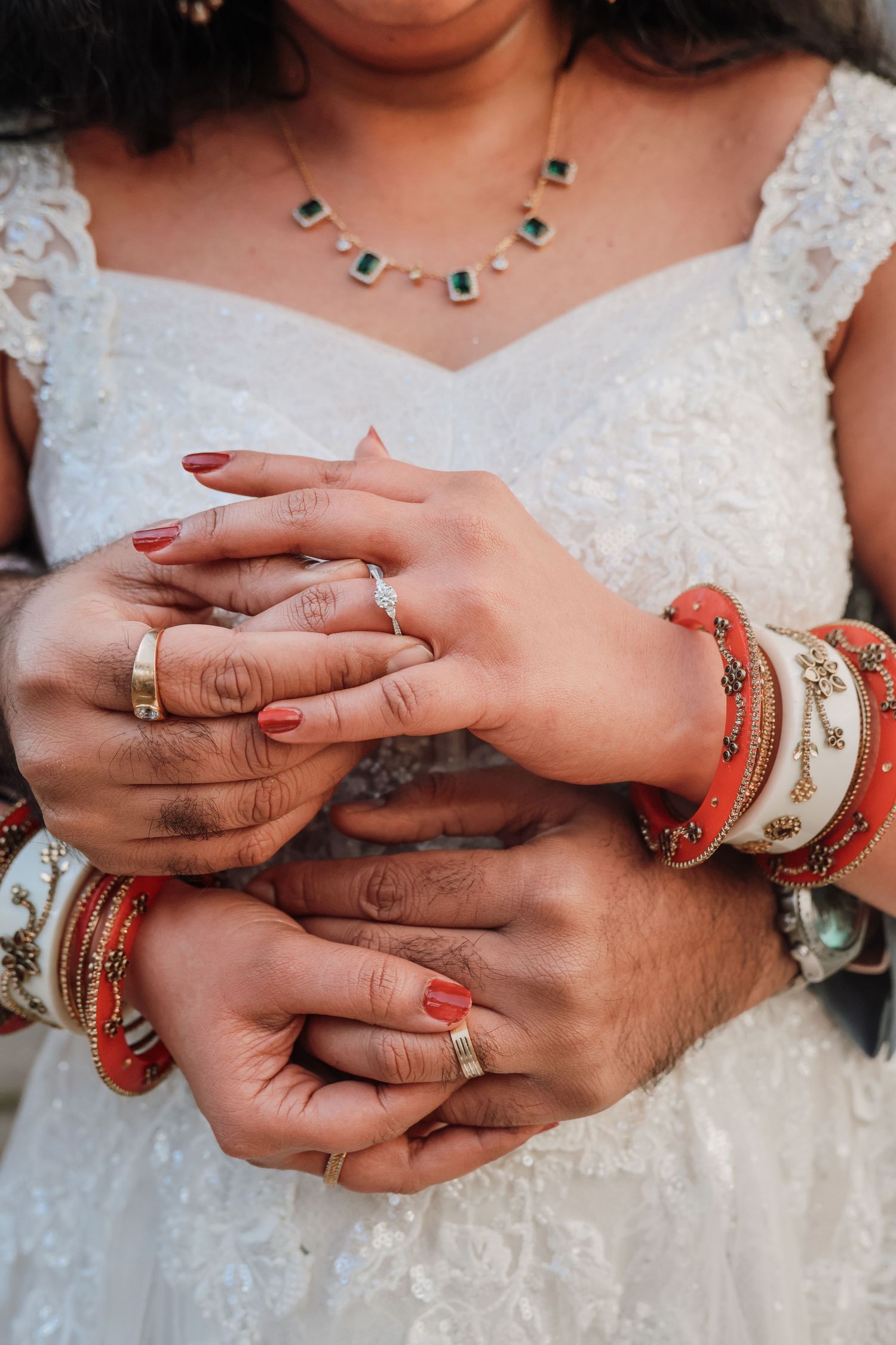 Close-up sequence of hands exchanging wedding rings during a multicultural ceremony with traditional Indian bangles.