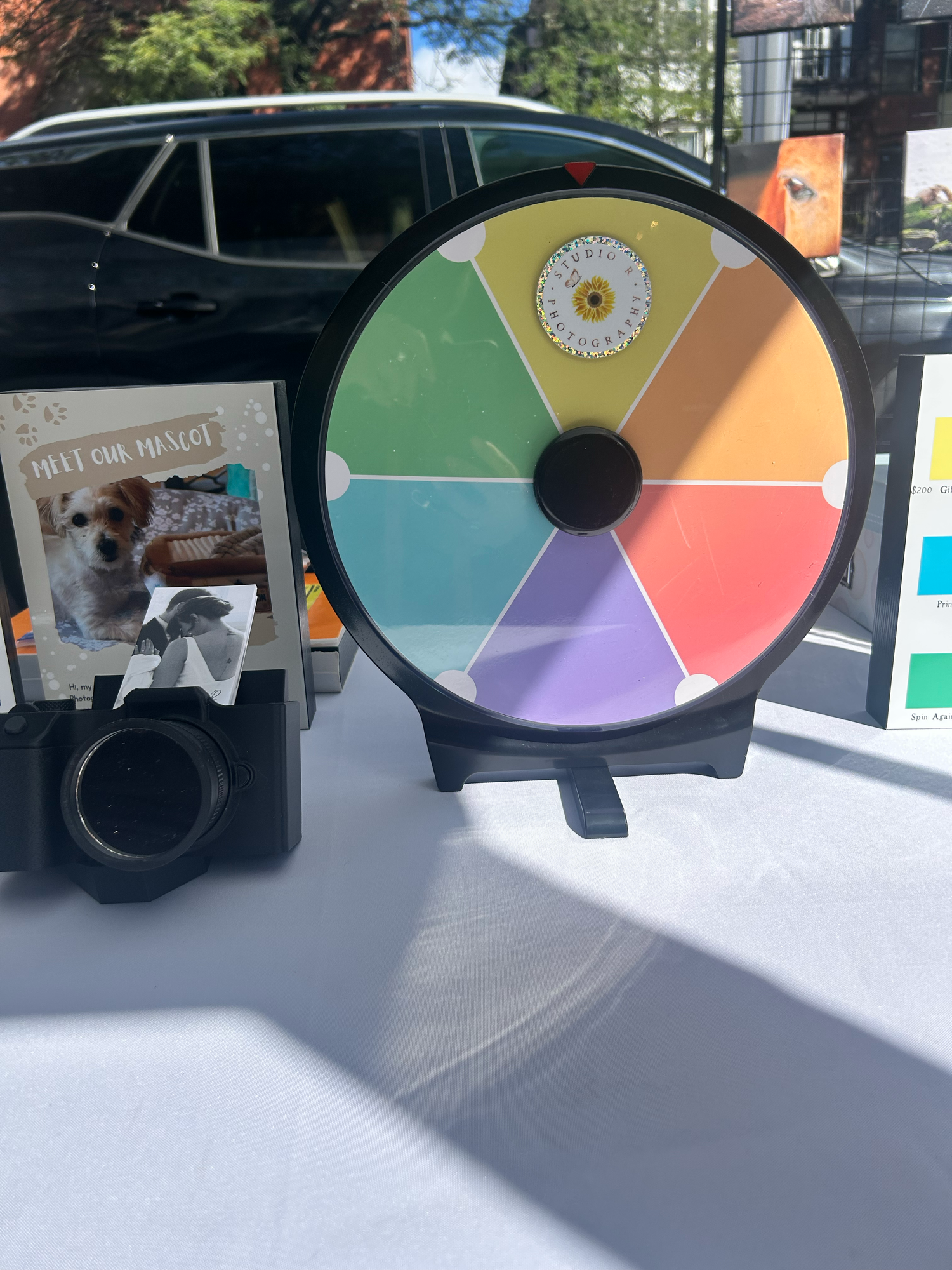 Multiple color wheels shown in varying angles arranged as a progression on a white surface with overhead lighting.