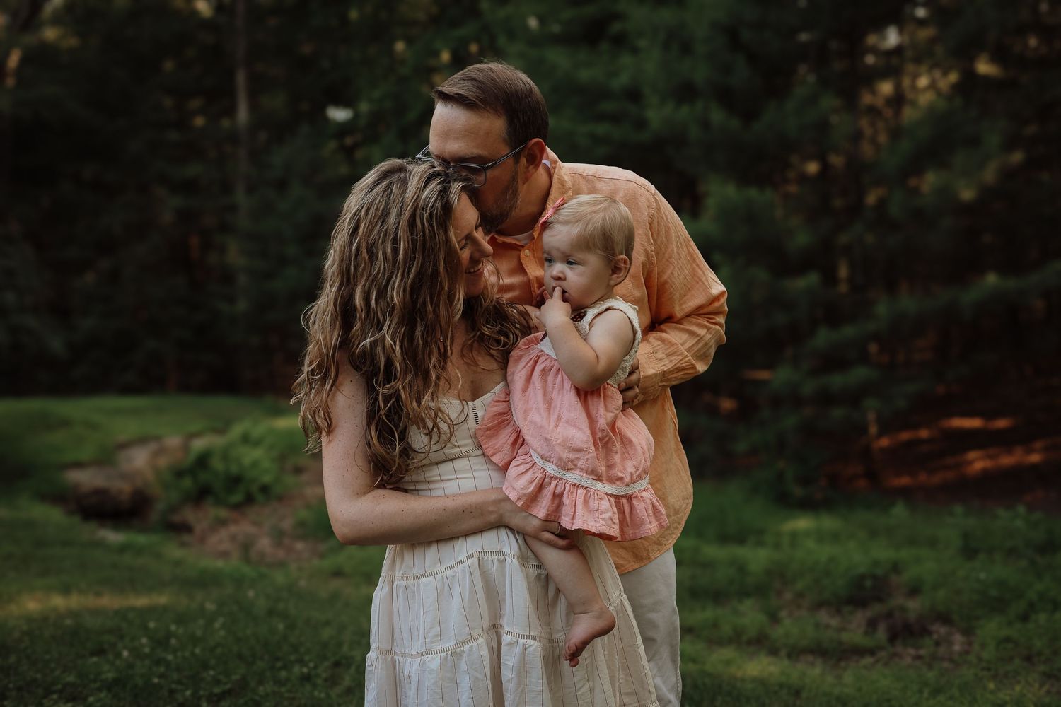 A collection of intimate outdoor family portraits showing tender moments between parents and children at sunset.