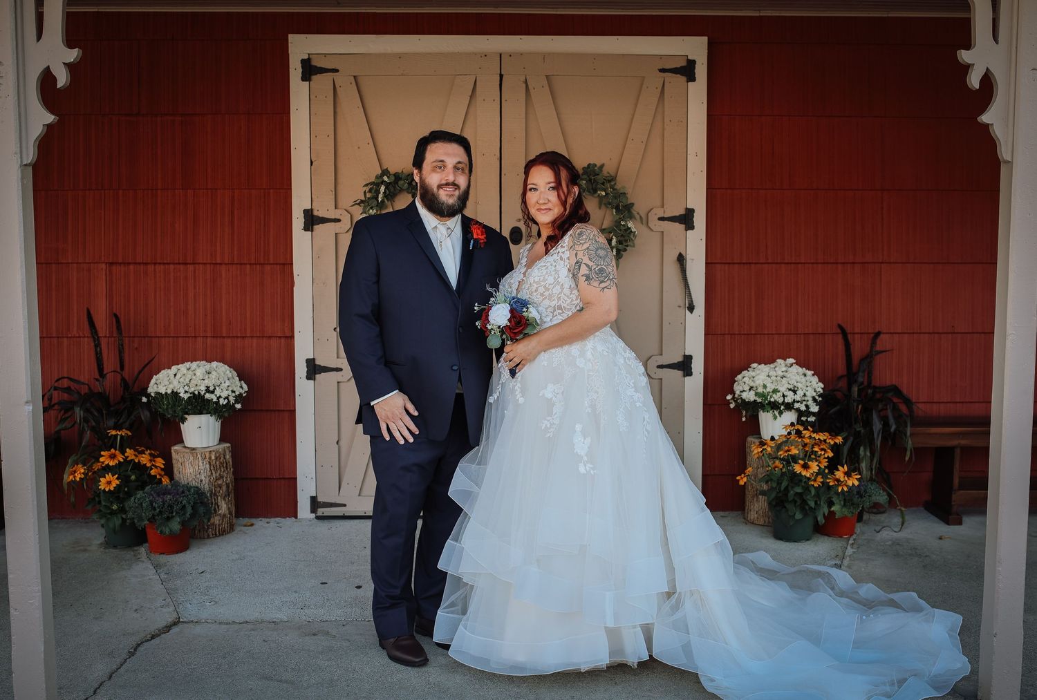 A sequence of romantic dance poses captured during a wedding celebration in front of a rustic red barn.