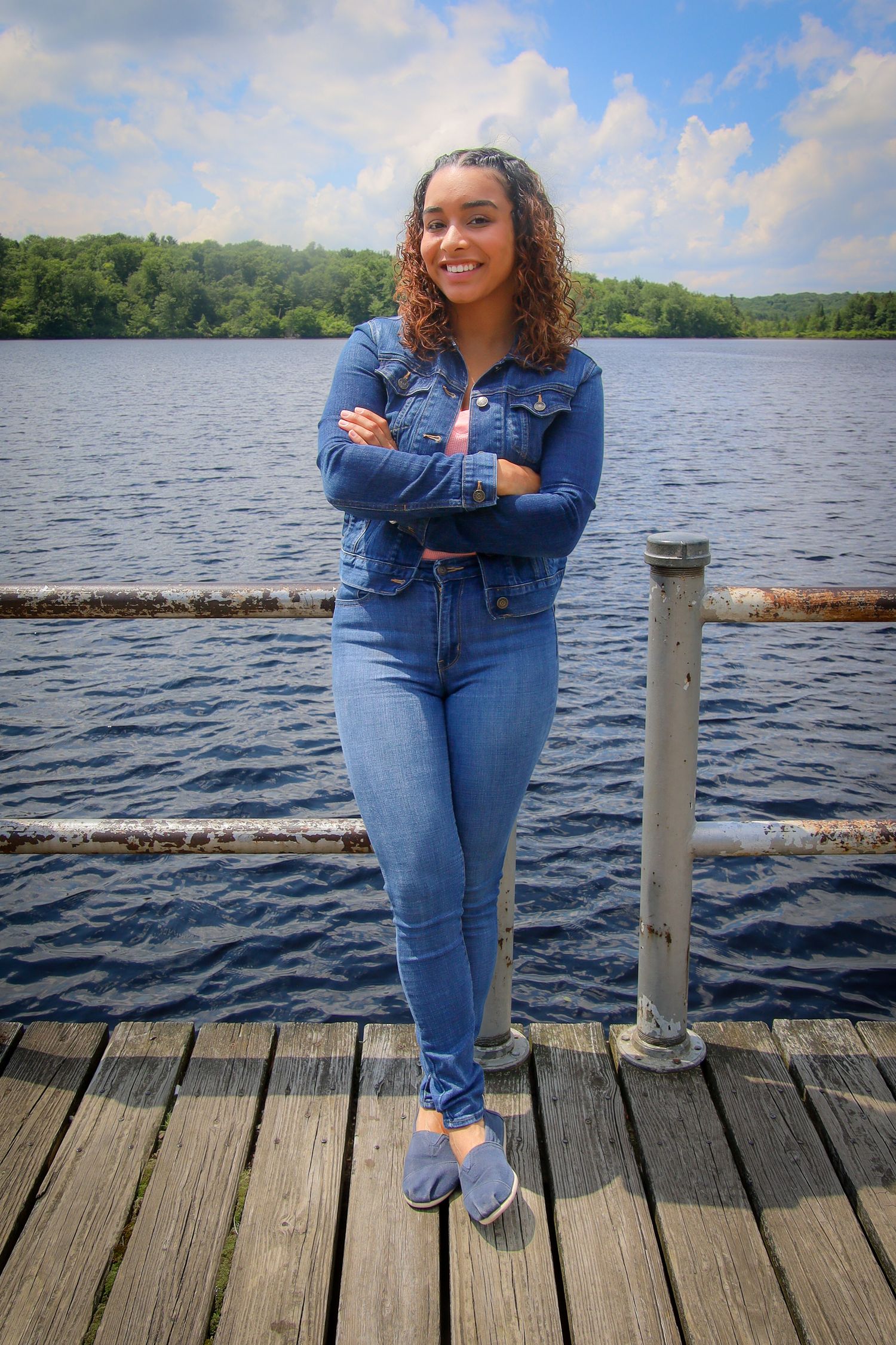 A series of photos on a wooden dock overlooking a serene lake with trees in the background.