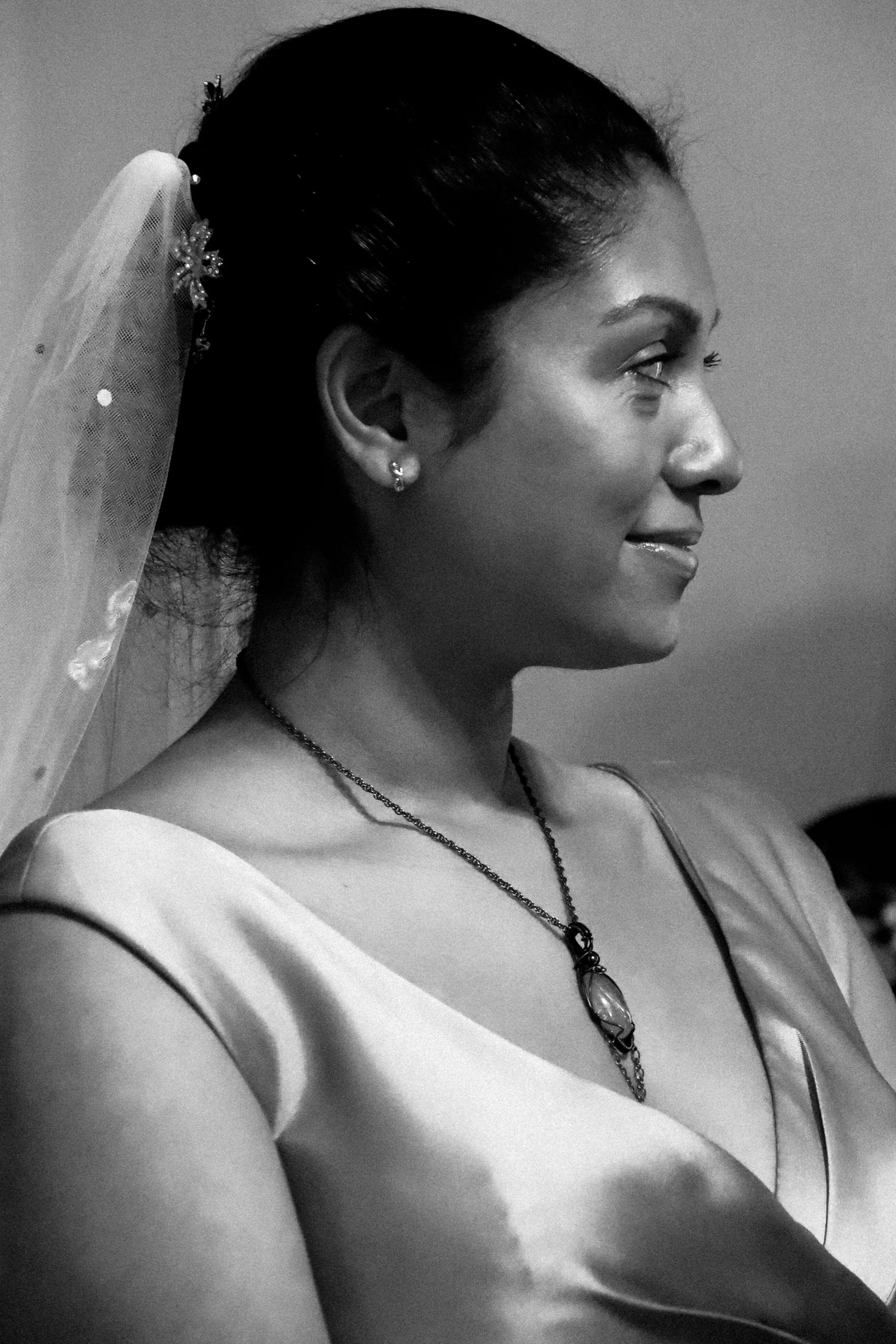 A series of black and white profile portraits showing a bride in a wedding veil and sleeveless dress.