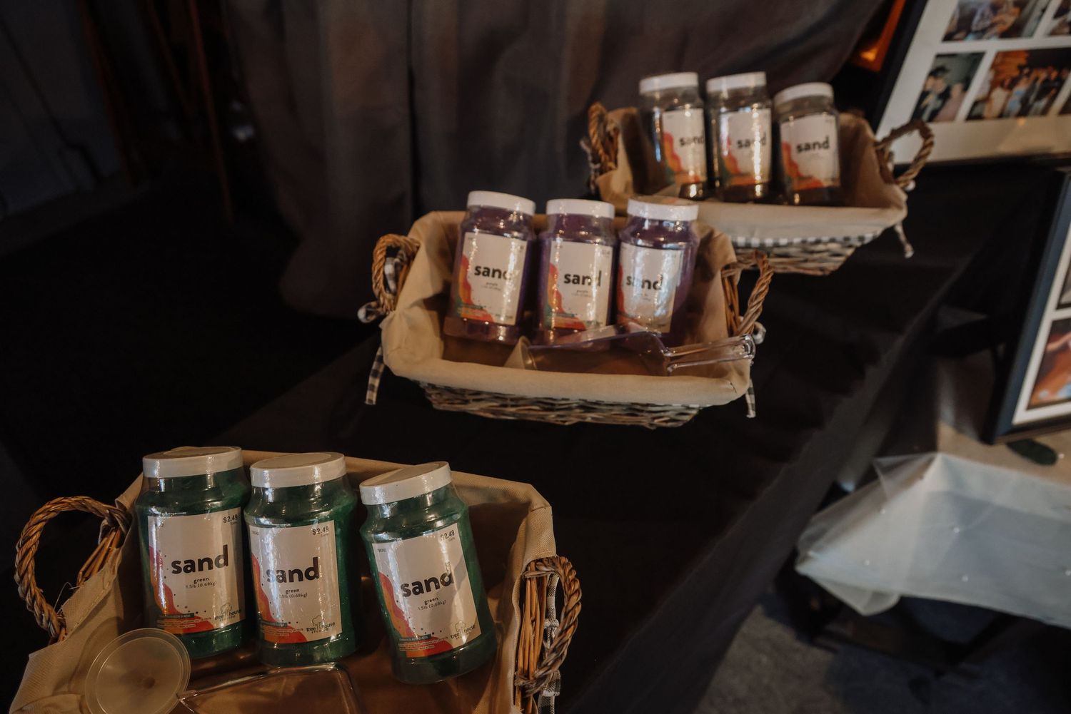 Assorted coffee bags displayed on rustic wooden serving trays in a dark retail setting.