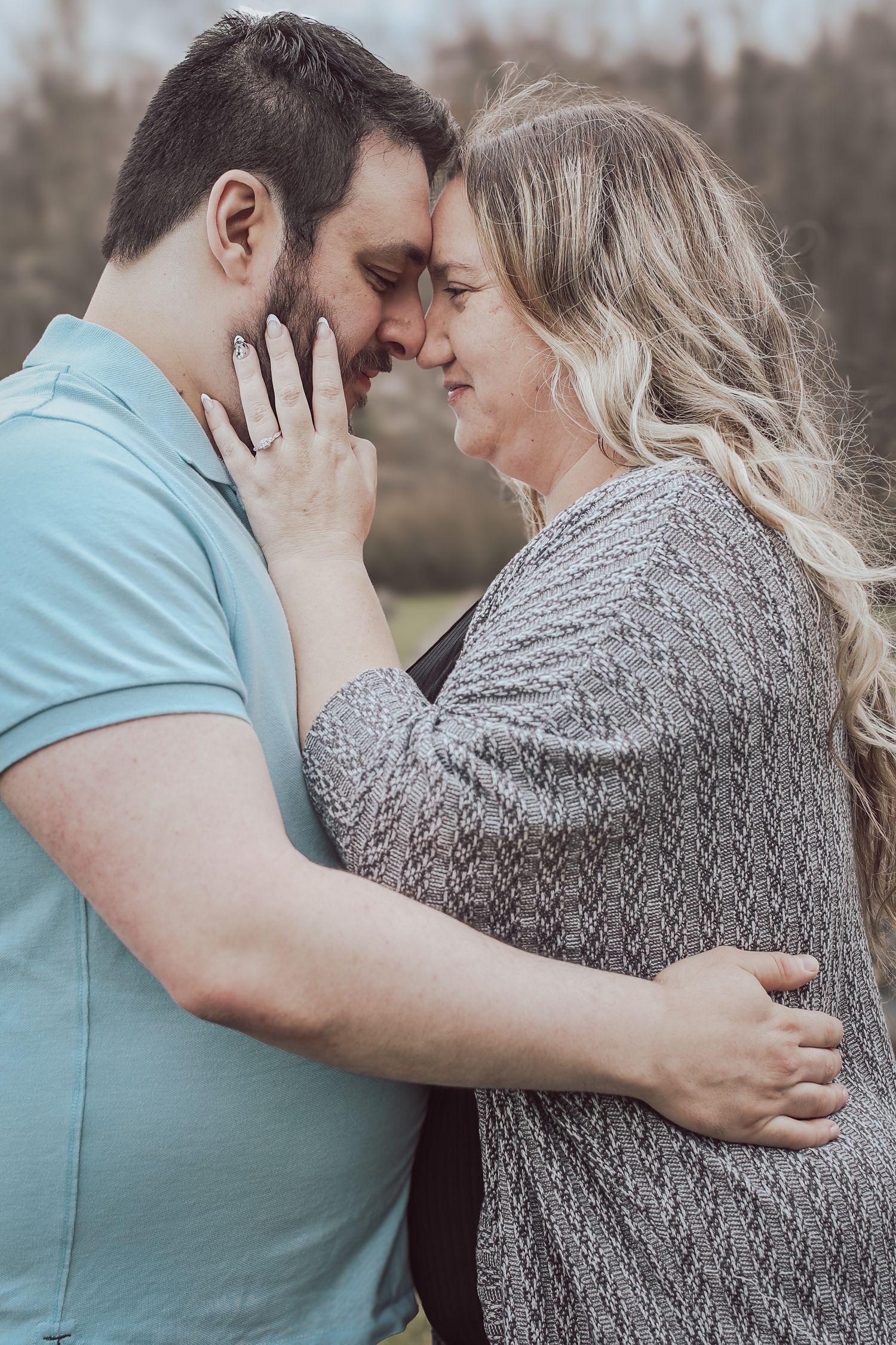 Romantic couple sharing intimate moments in a series of tender embraces outdoors on an overcast day.