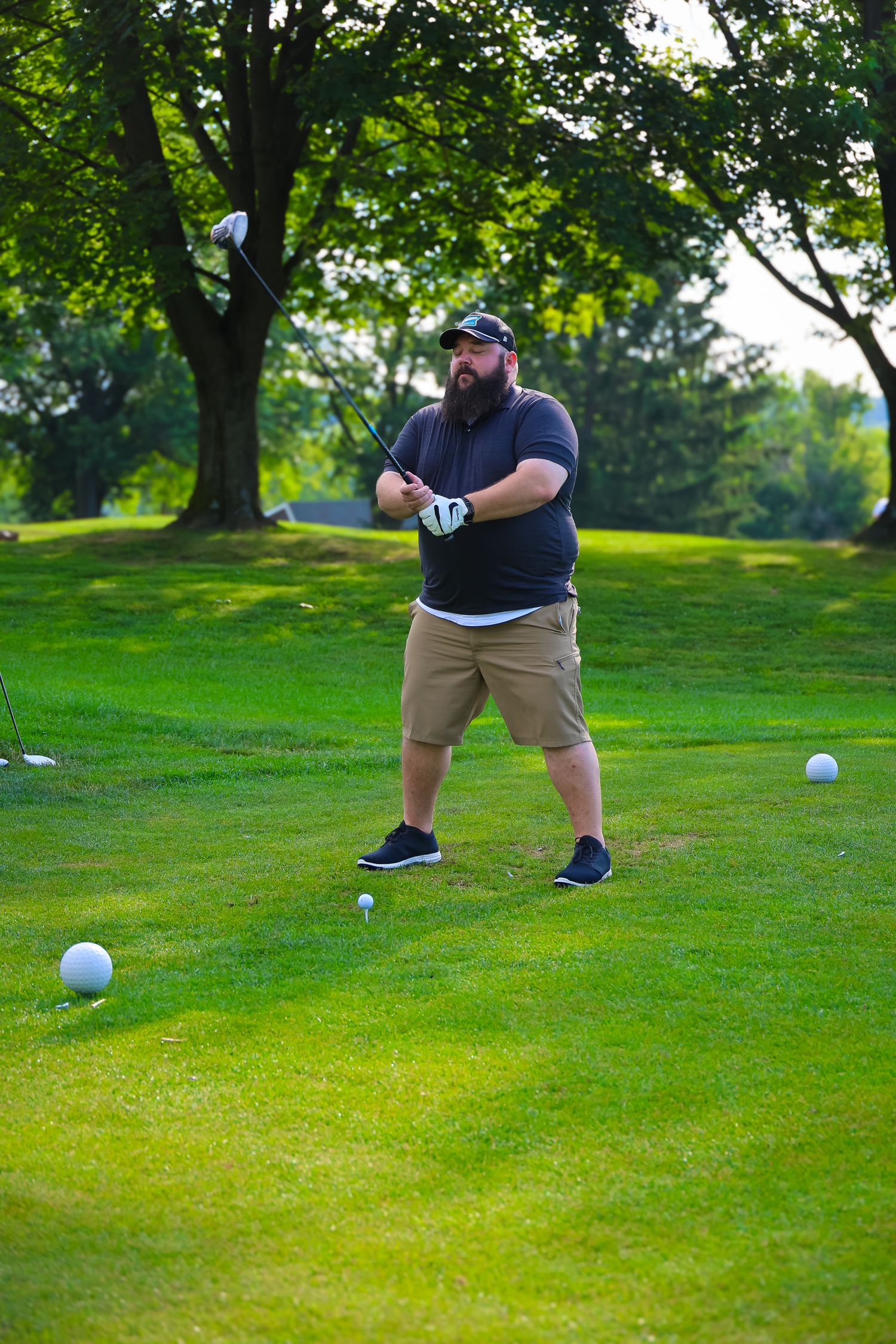 Sequence showing a golfer preparing and executing a putt on a lush green golf course during a sunny day.