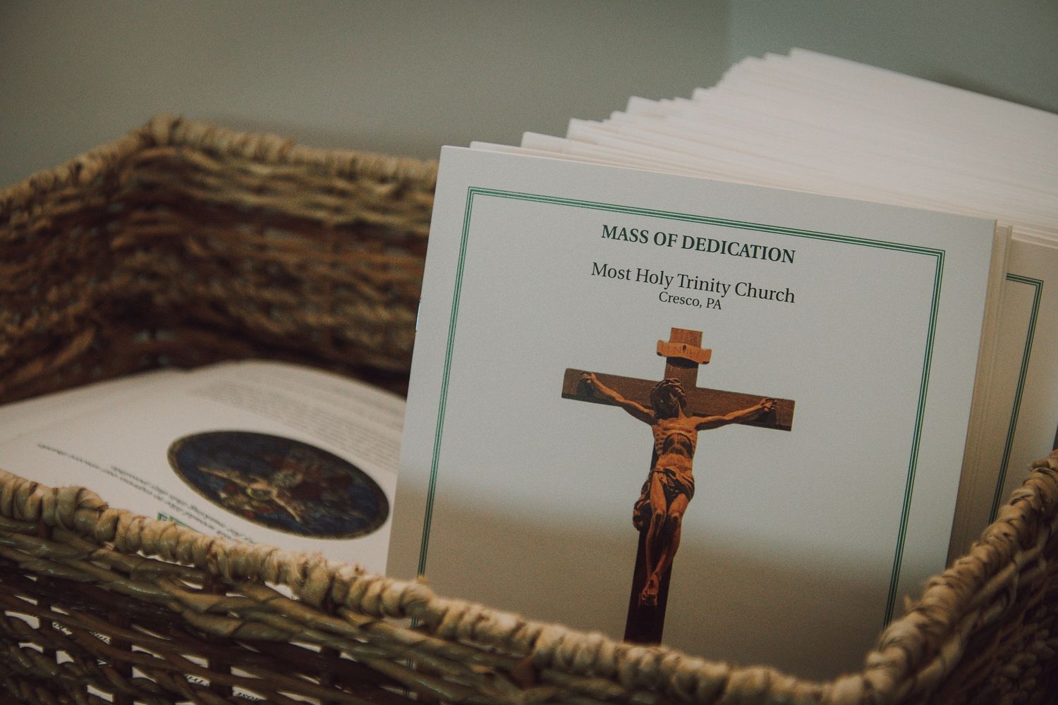 A collection of religious texts and crucifixes arranged in a row against a muted background.