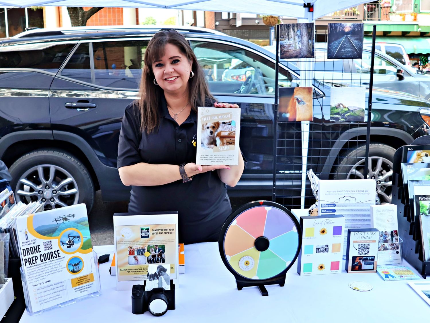 A row of multiple computer CD and DVD discs displayed on a table at a technology event.