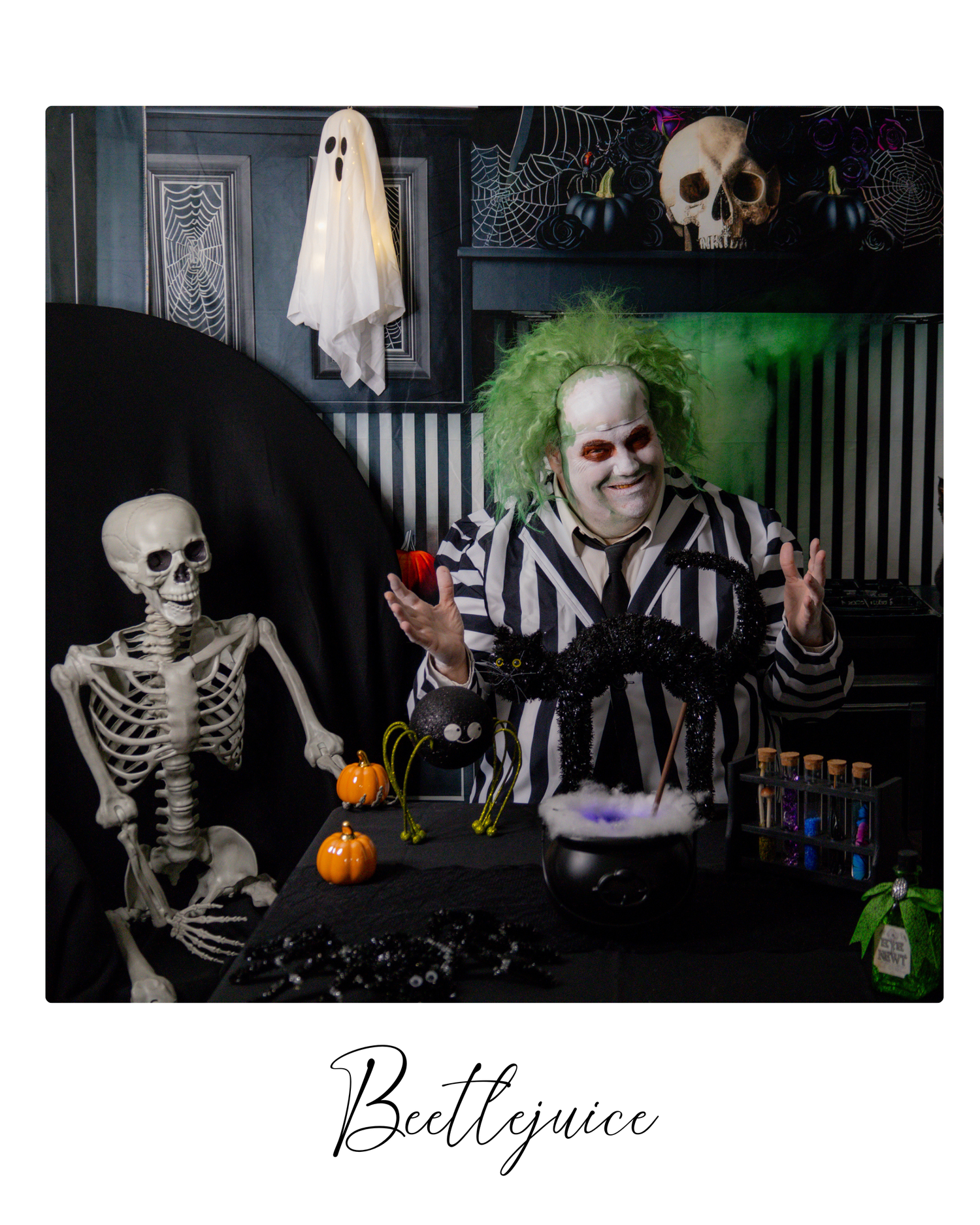 Spooky Halloween decorations featuring skeletons, pumpkins, and ghostly figures arranged in a dark indoor setting.