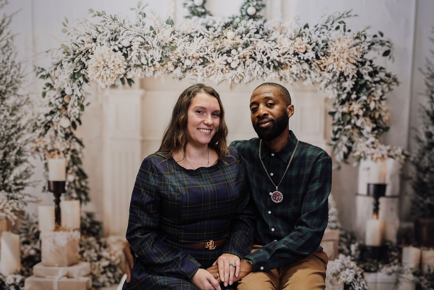A couple in dark clothing shares candid moments in a photo collage with floral decor in the background.