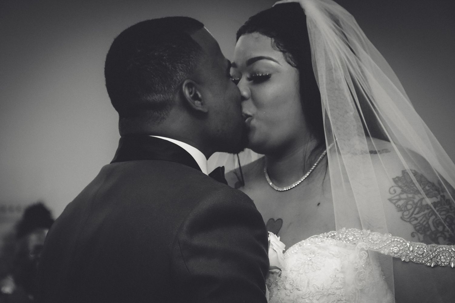 A series of black and white romantic wedding photos showing intimate moments between a bride and groom.