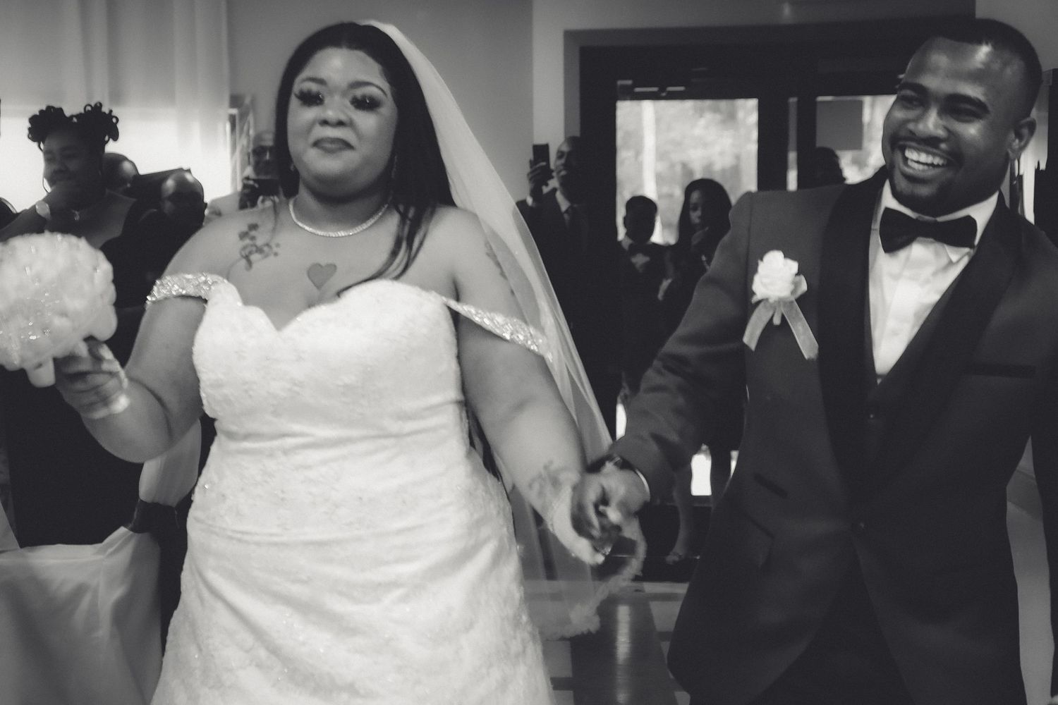 Wedding guests dance and celebrate on the dance floor at a joyful reception celebration.