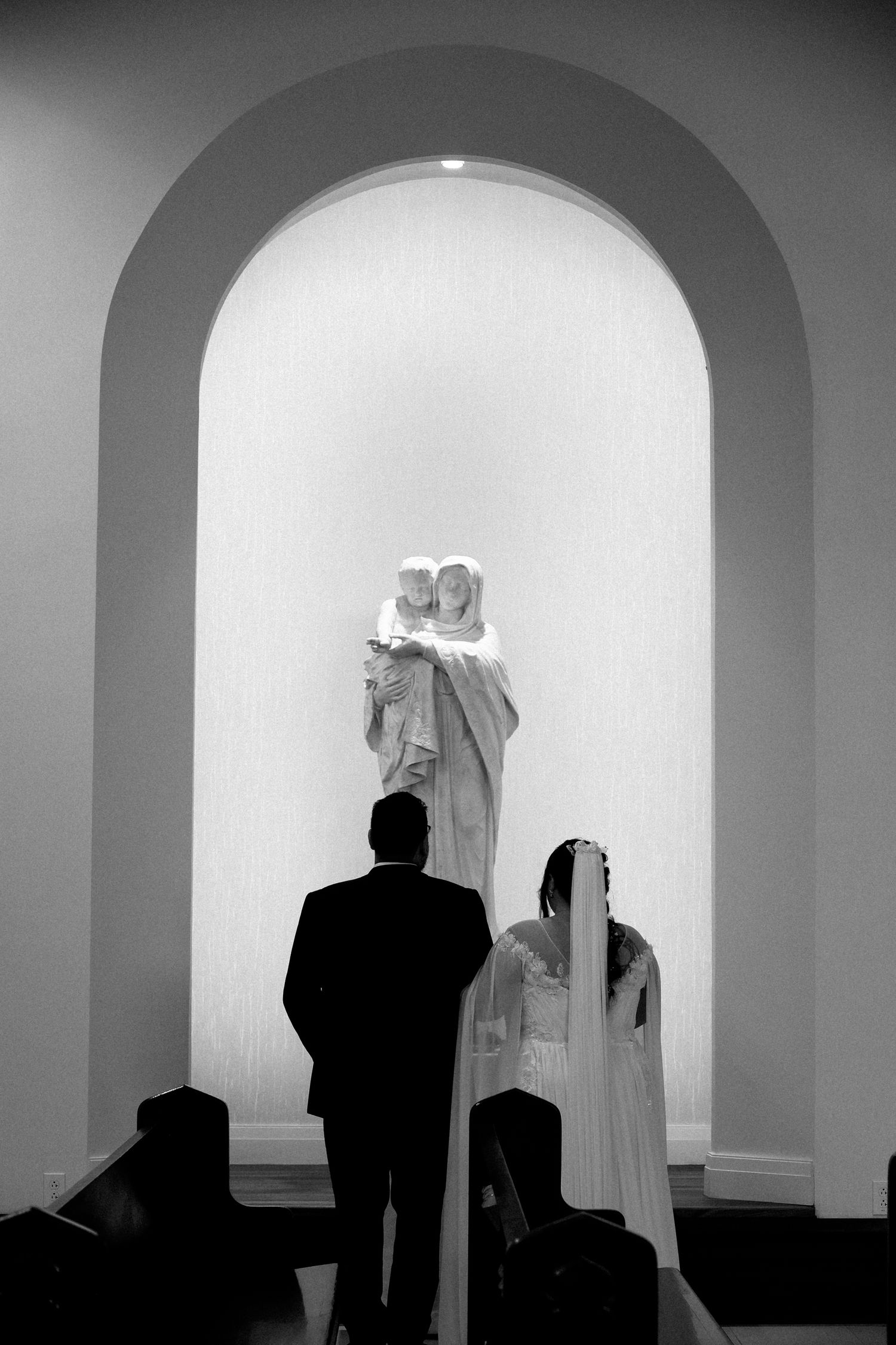 A series of black and white photos showing silhouettes of people against arched doorways in a minimalist architectural setting.