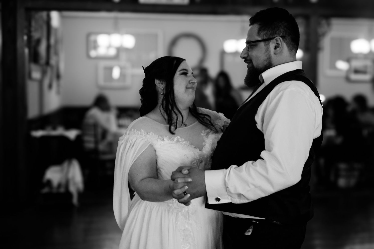 A black and white photo montage showing couples dancing together at a wedding reception.