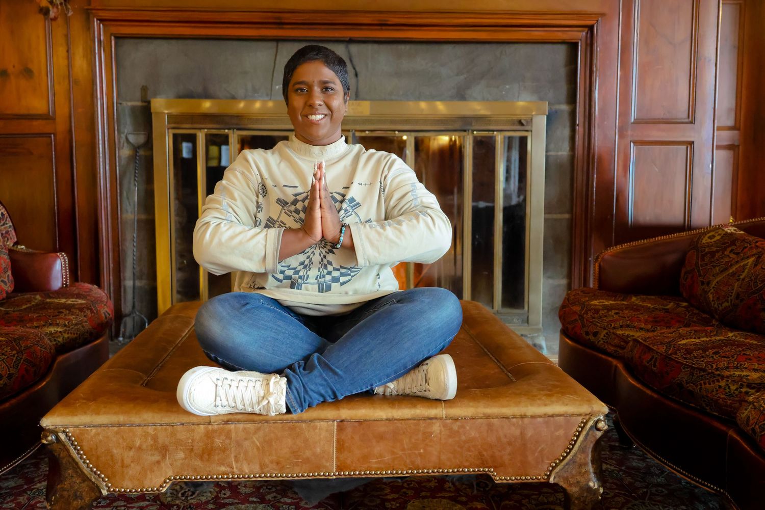 A series of five photos showing someone sitting on a leather couch in different relaxed poses.