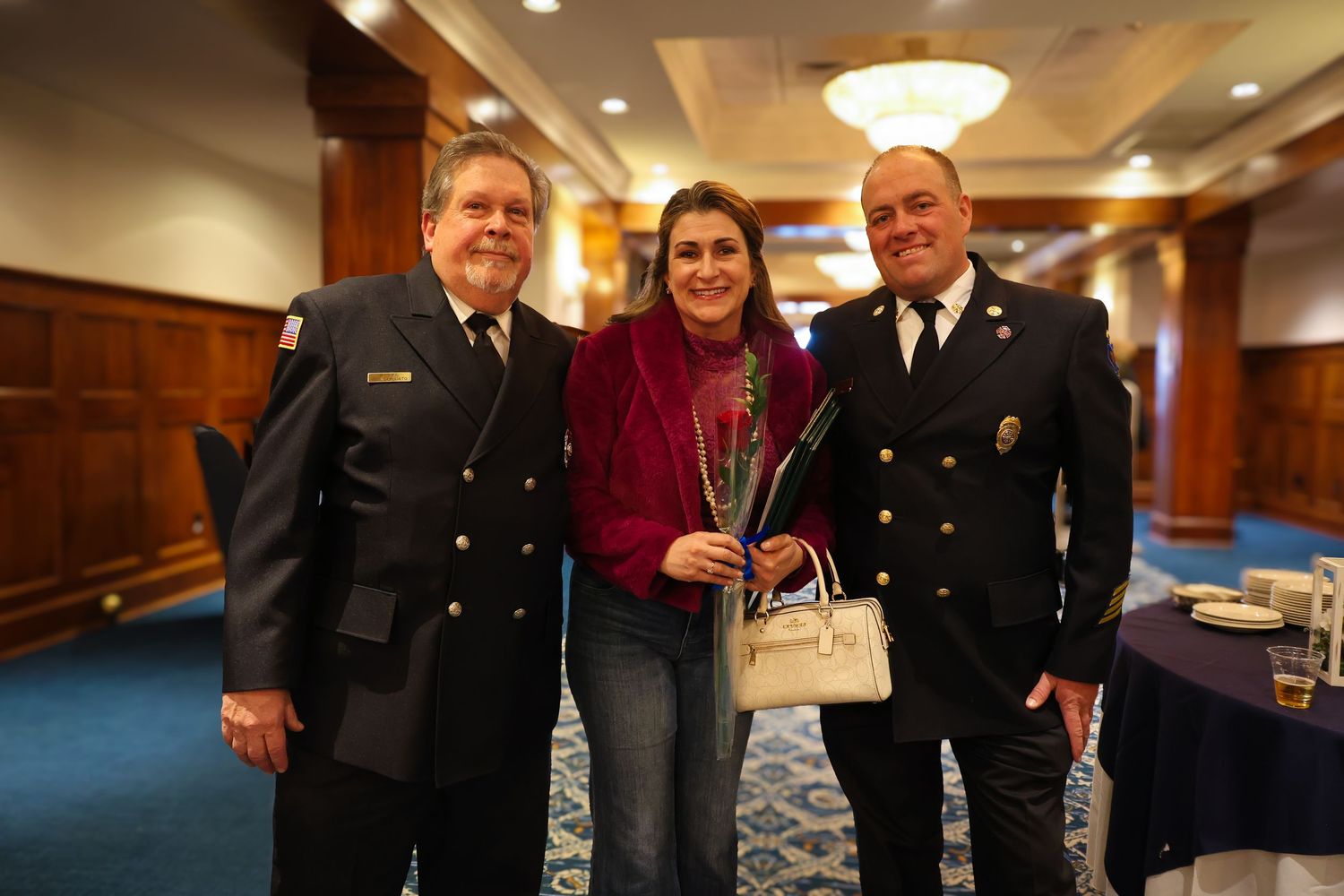 Military service members and guests gather in a formal reception hall during an awards ceremony or celebration.