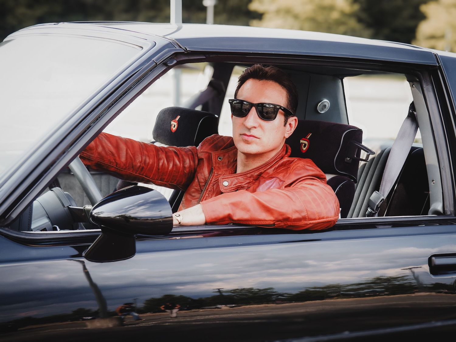 A series of side profile shots showing someone wearing sunglasses while sitting in a car.
