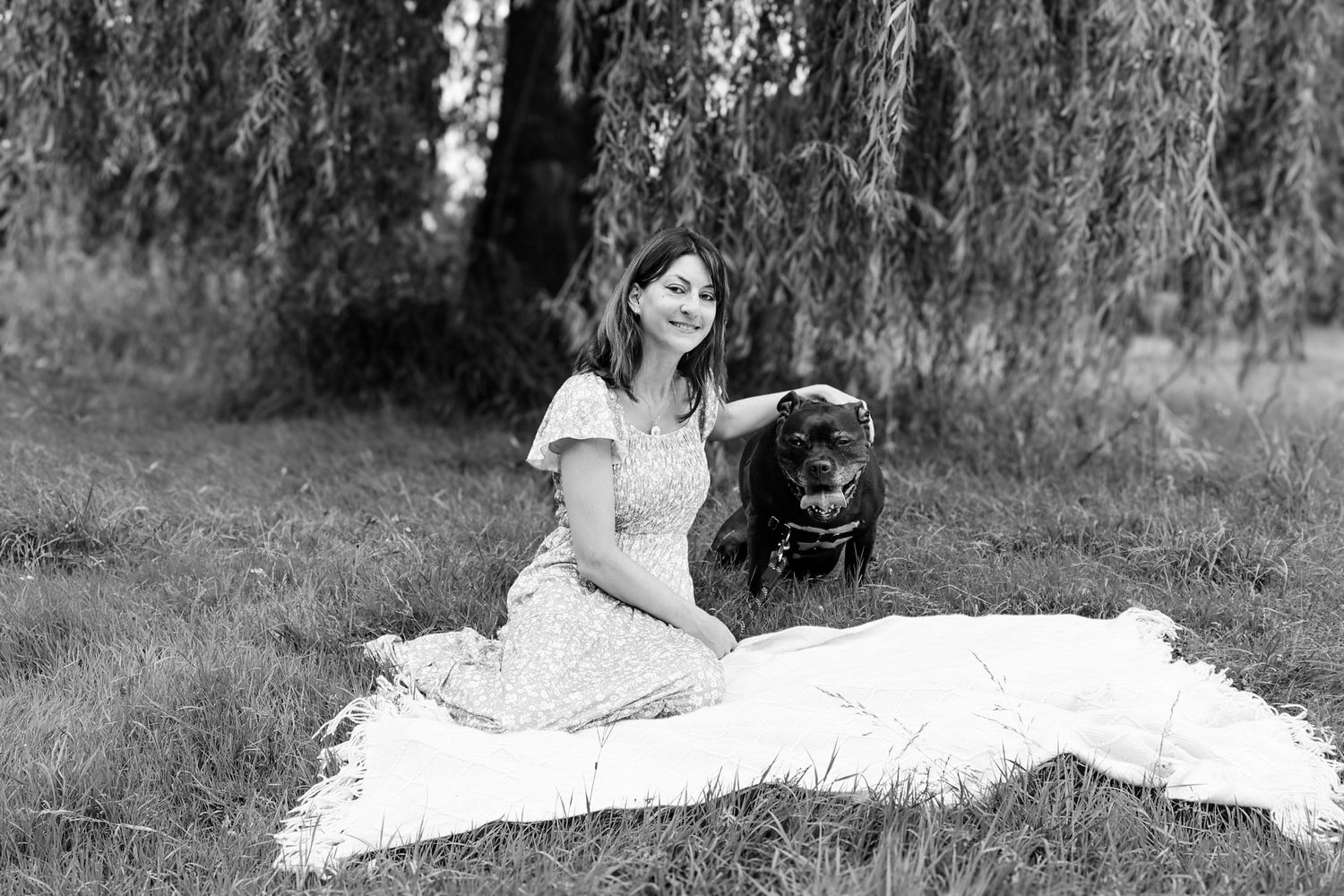 Black and white wedding photo series showing romantic moments and a large fluffy dress in an outdoor garden setting.