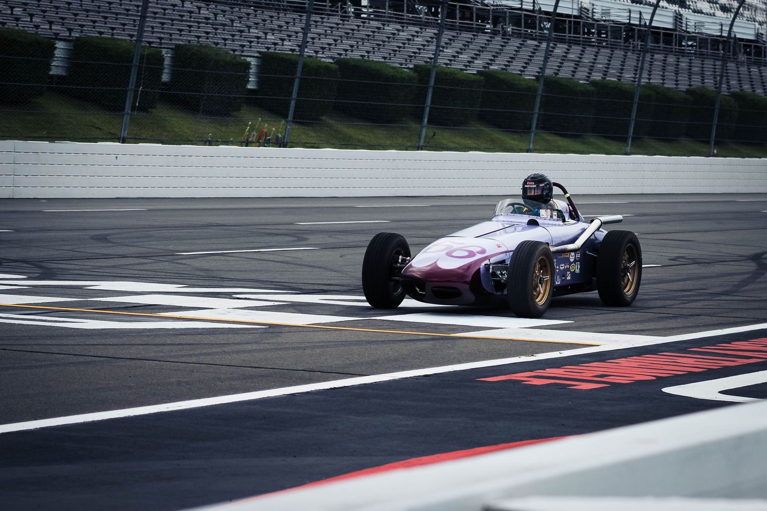 Formula race cars speed around a racetrack with a checkered finish line visible in multiple action shots.