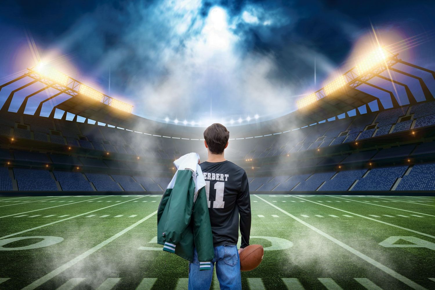 Football stadium at night with dramatic lighting and fog creating an atmospheric sports venue atmosphere.